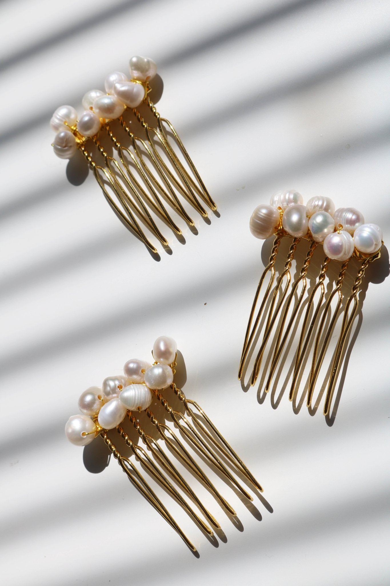 Three smaller sized pearl clustered hair combs in gold. Affordable Canadian jewelry brands. Handmade Canadian jewelry. Canadian jewelry business. Organic pearl jewelry. Pearl jewelry sets. Bridal jewelry Canada. Pearl jewelry Canada. Pearl Bridal jewelry Canada.    Canadian jewelry designer. Canadian jewelry designs.