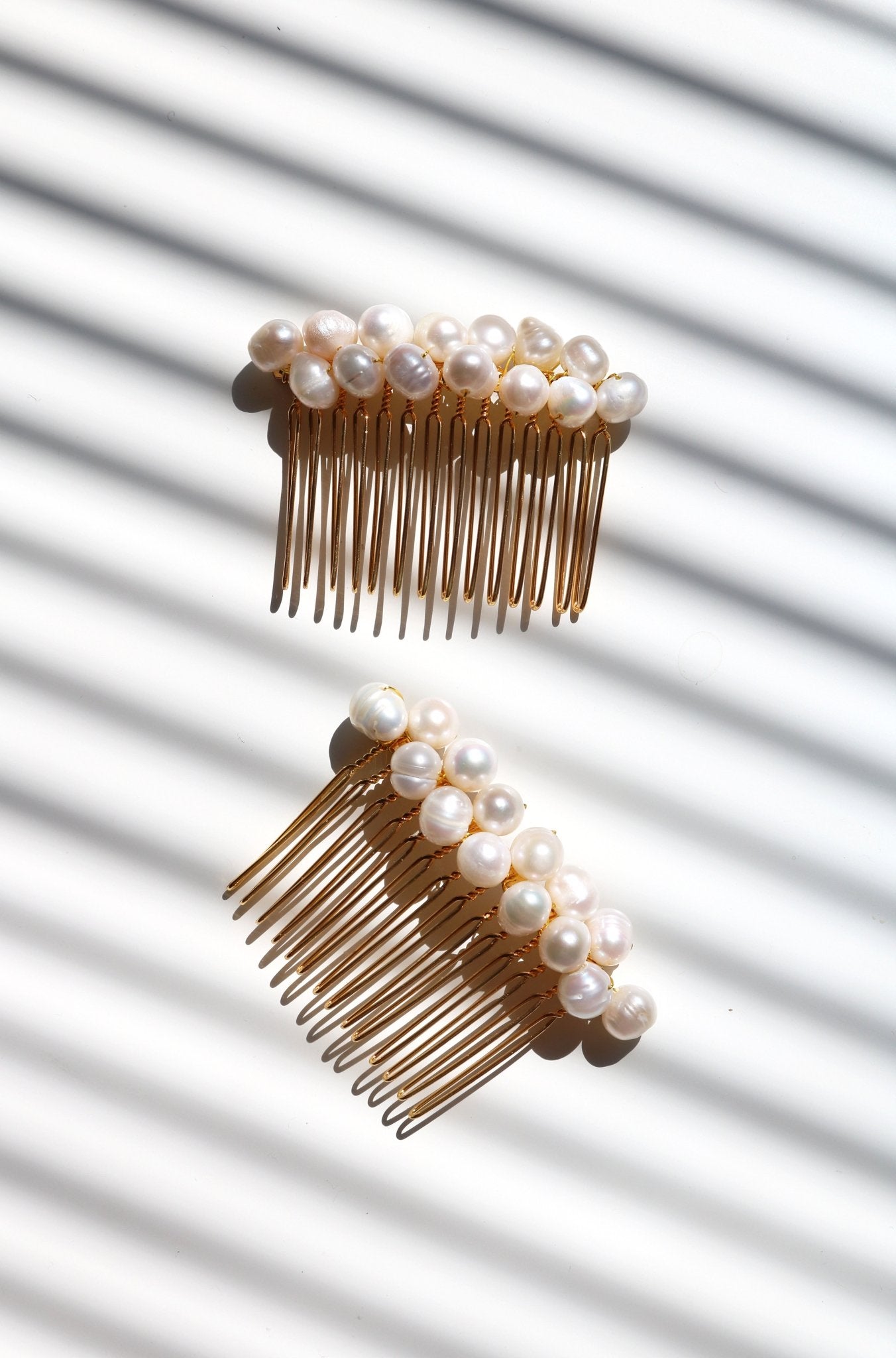 Two gold freshwater pearl hair combs on a white background. Freshwater Pearl Bridal jewelry made in Canada by affordable jewelry brand.