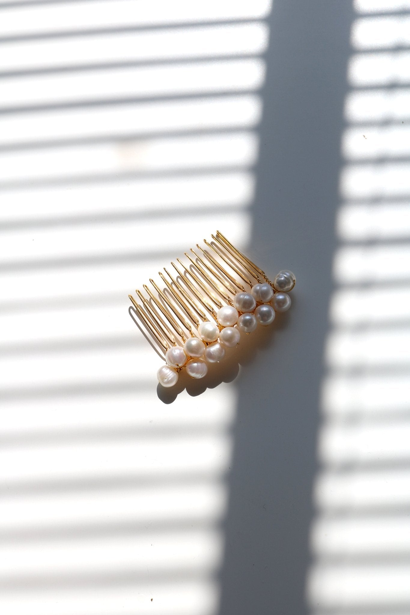 Large golden hair comb with multiple freshwater pearls. Affordable Canadian jewelry brands. Handmade Canadian jewelry. Canadian jewelry business. Organic pearl jewelry. Pearl jewelry sets. Bridal jewelry Canada. Pearl jewelry Canada. Pearl Bridal jewelry Canada. Canadian jewelry designer. Canadian jewelry designs. Pearl Hair Accessories. Bridal Hair accessories.