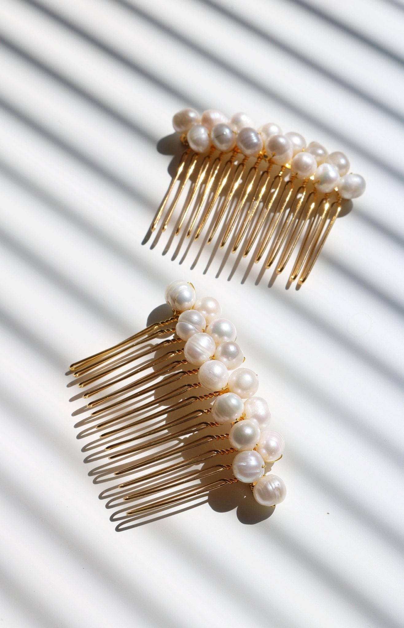 Two Adelle Fresh Water Pearl Combs in gold. Affordable Canadian jewelry brands. Handmade Canadian jewelry. Canadian jewelry business. Organic pearl jewelry. Pearl jewelry sets. Bridal jewelry Canada. Pearl jewelry Canada. Pearl Bridal jewelry Canada. Canadian jewelry designer. Canadian jewelry designs. Pearl Hair Accessories. Bridal Hair accessories.
