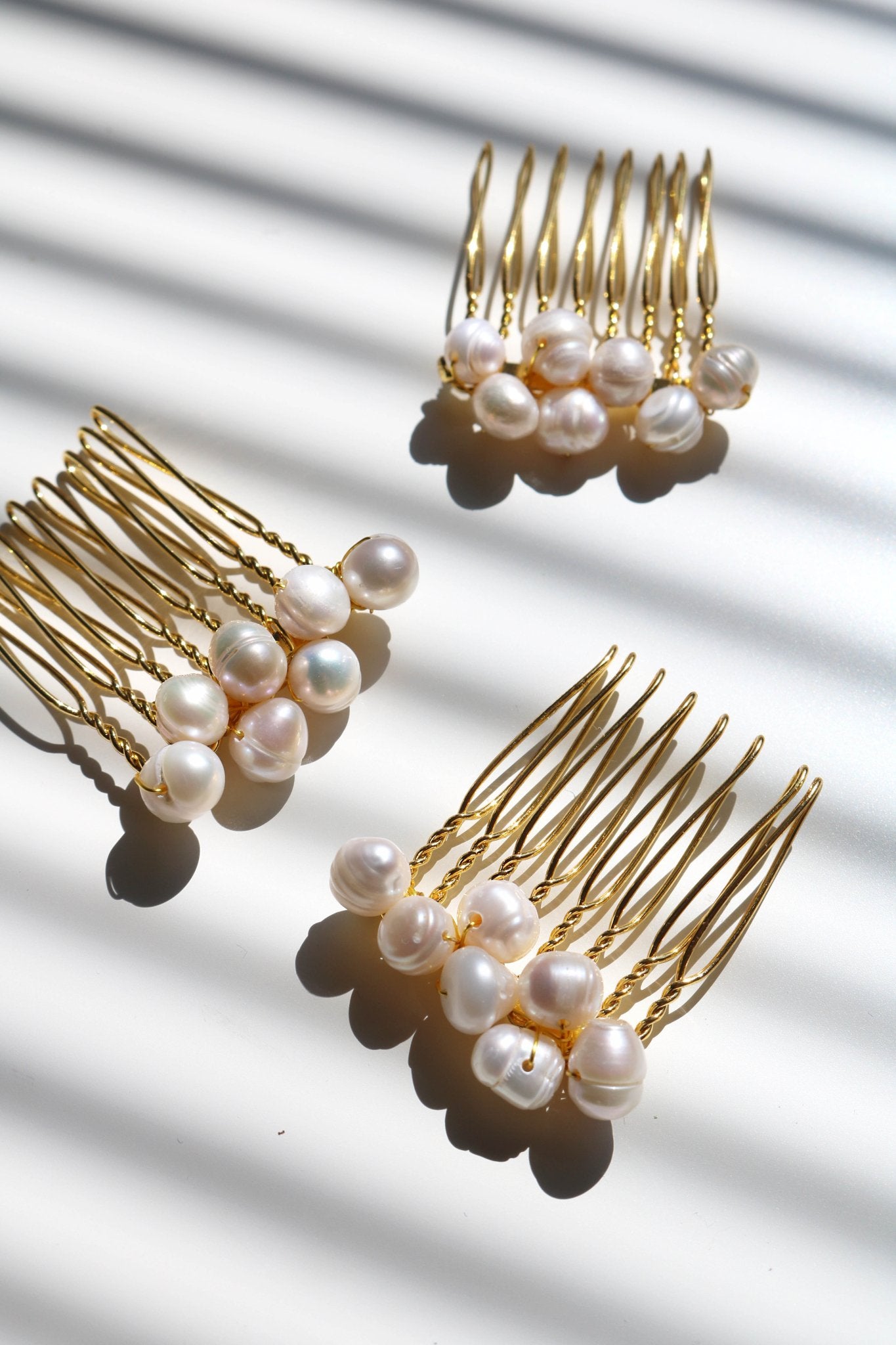 Three medium gold bridal haircombs with bigger clustered pearls. Affordable Canadian jewelry brands. Handmade Canadian jewelry. Canadian jewelry business. Organic pearl jewelry. Pearl jewelry sets. Bridal jewelry Canada. Pearl jewelry Canada. Pearl Bridal jewelry Canada.    Canadian jewelry designer. Canadian jewelry designs. Pearl Hair Accessories.