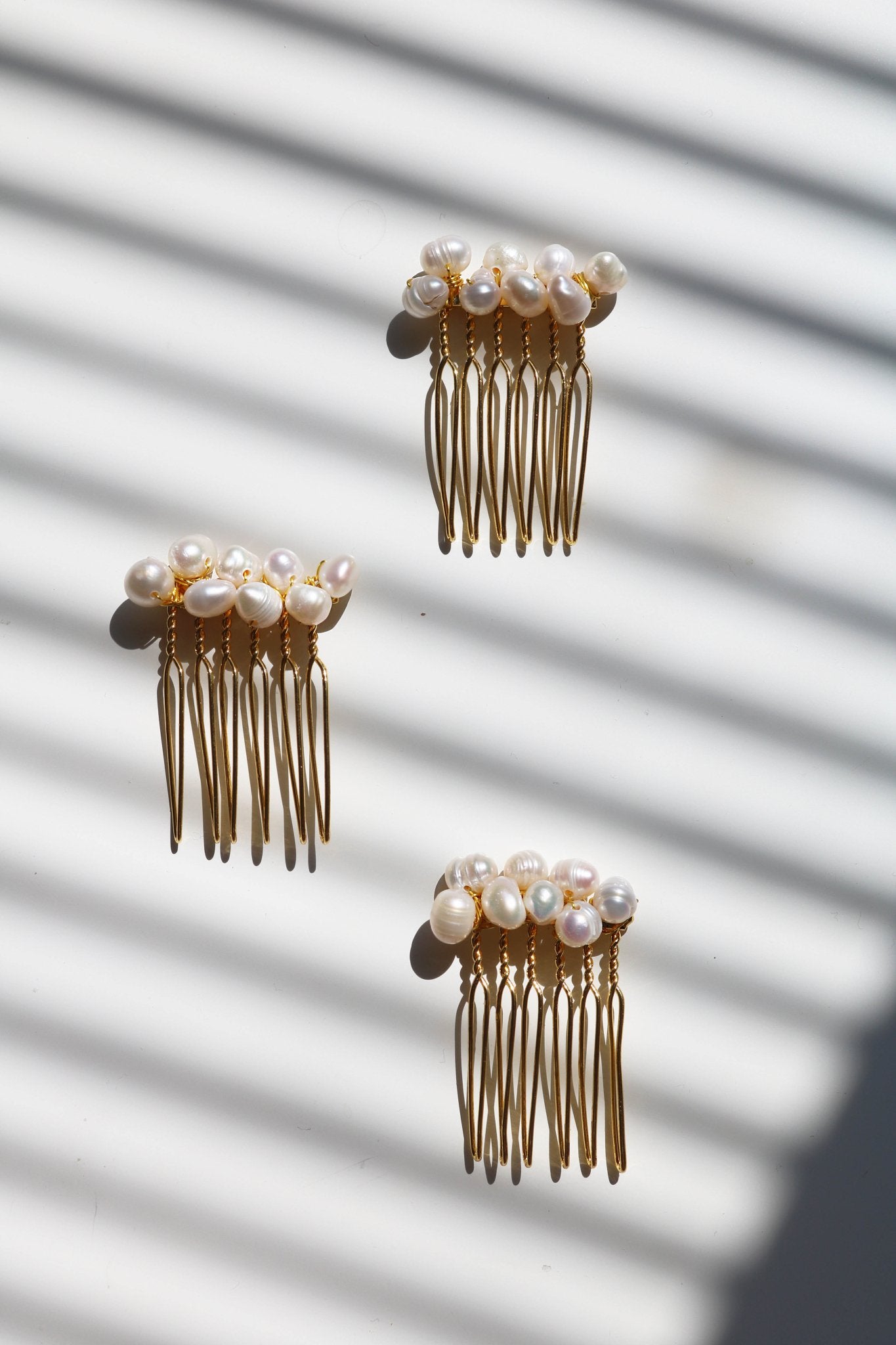 Three gold-filled freshwater pearl cluster hair combs. Affordable Canadian jewelry brands. Handmade Canadian jewelry. Canadian jewelry business. Organic pearl jewelry. Pearl jewelry sets. Bridal jewelry Canada. Pearl jewelry Canada. Pearl Bridal jewelry Canada. Canadian jewelry designer. Canadian jewelry designs. Pearl Hair Accessories. Bridal Hair accessories.