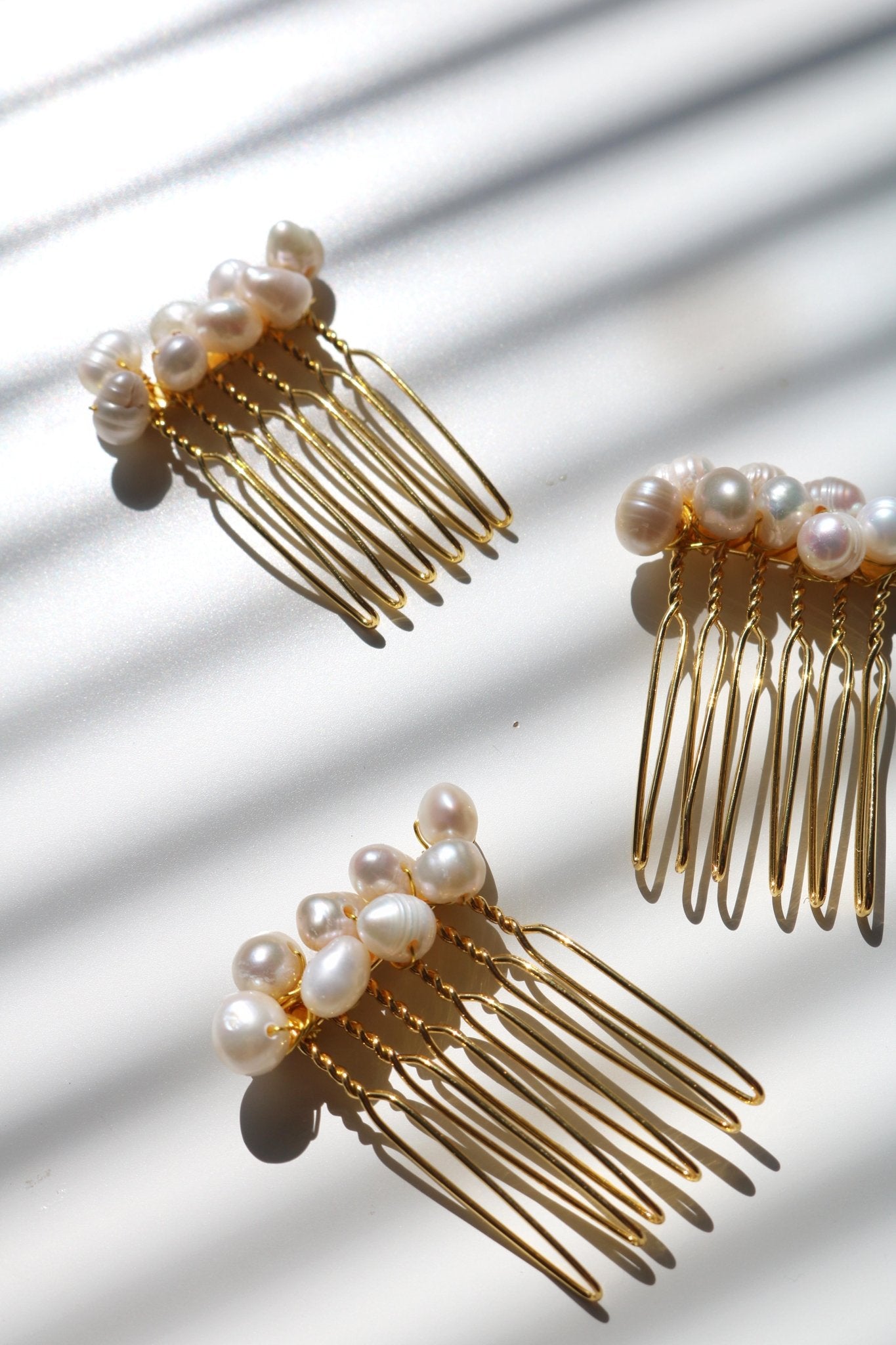 Three gold multi-pearl hair combs for bridal. Affordable Canadian jewelry brands. Handmade Canadian jewelry. Canadian jewelry business. Organic pearl jewelry. Pearl jewelry sets. Bridal jewelry Canada. Pearl jewelry Canada. Pearl Bridal jewelry Canada. Canadian jewelry designer. Canadian jewelry designs. Pearl Hair Accessories. Bridal Hair accessories.