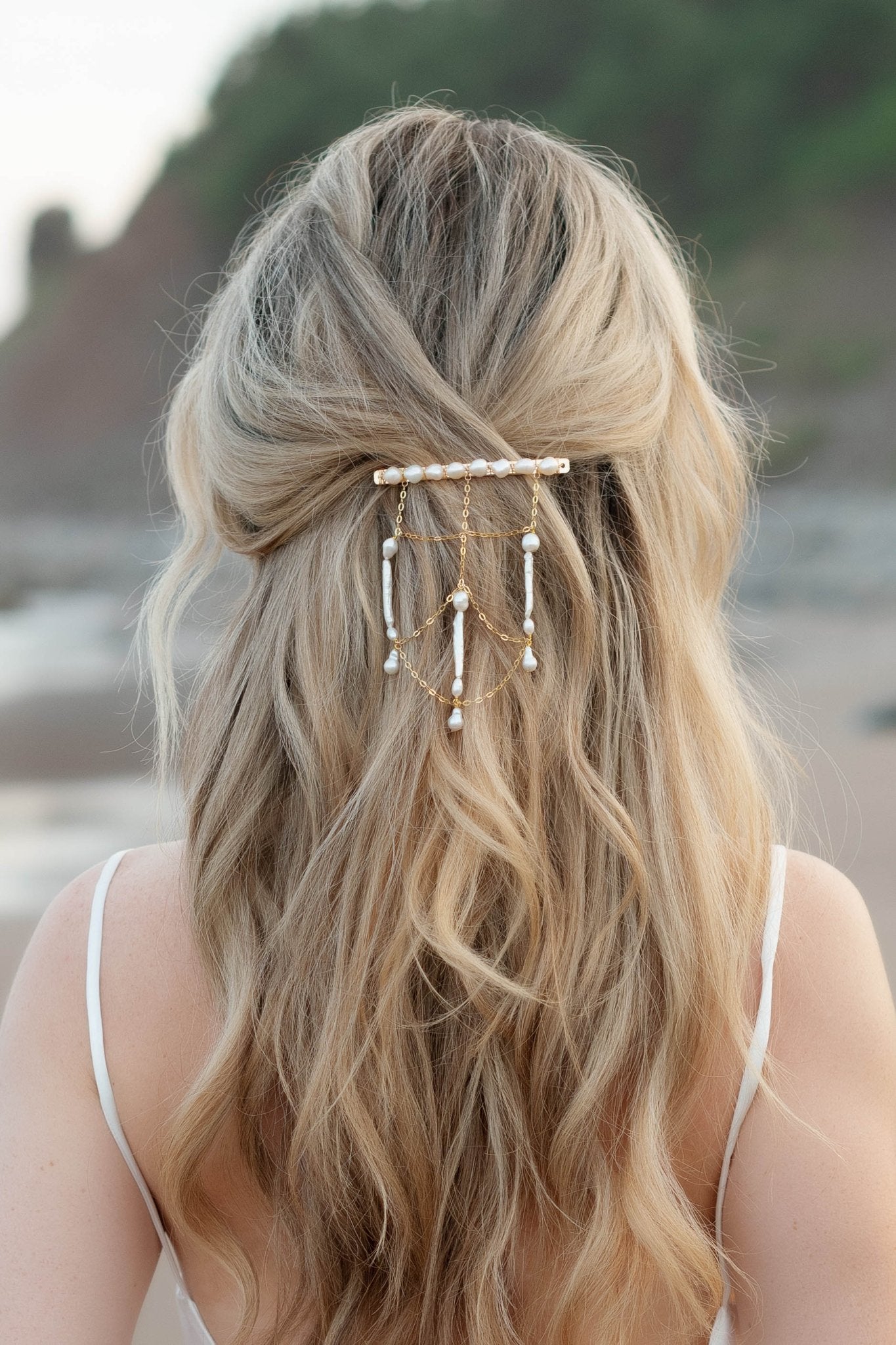 Golden netted hair chain and barrette with multiple freshwater pearls cascades down a wave of blonde hair. Pearl Bridal jewelry Canada. Canadian jewelry brands.