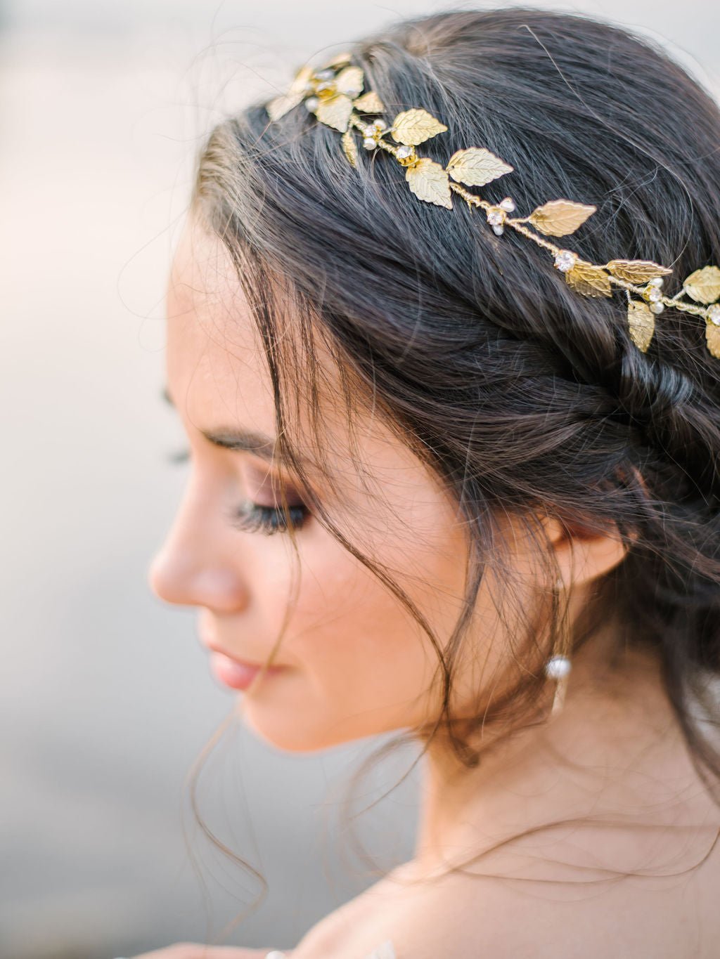 Close up of a golden leaf and crystal freshwater pearl bridal hair circlet adorns a blushing bride by the seaside. Bridal Hair Accessories, Canadian Bridal Accessories, & Handmade Canadian Accessories.