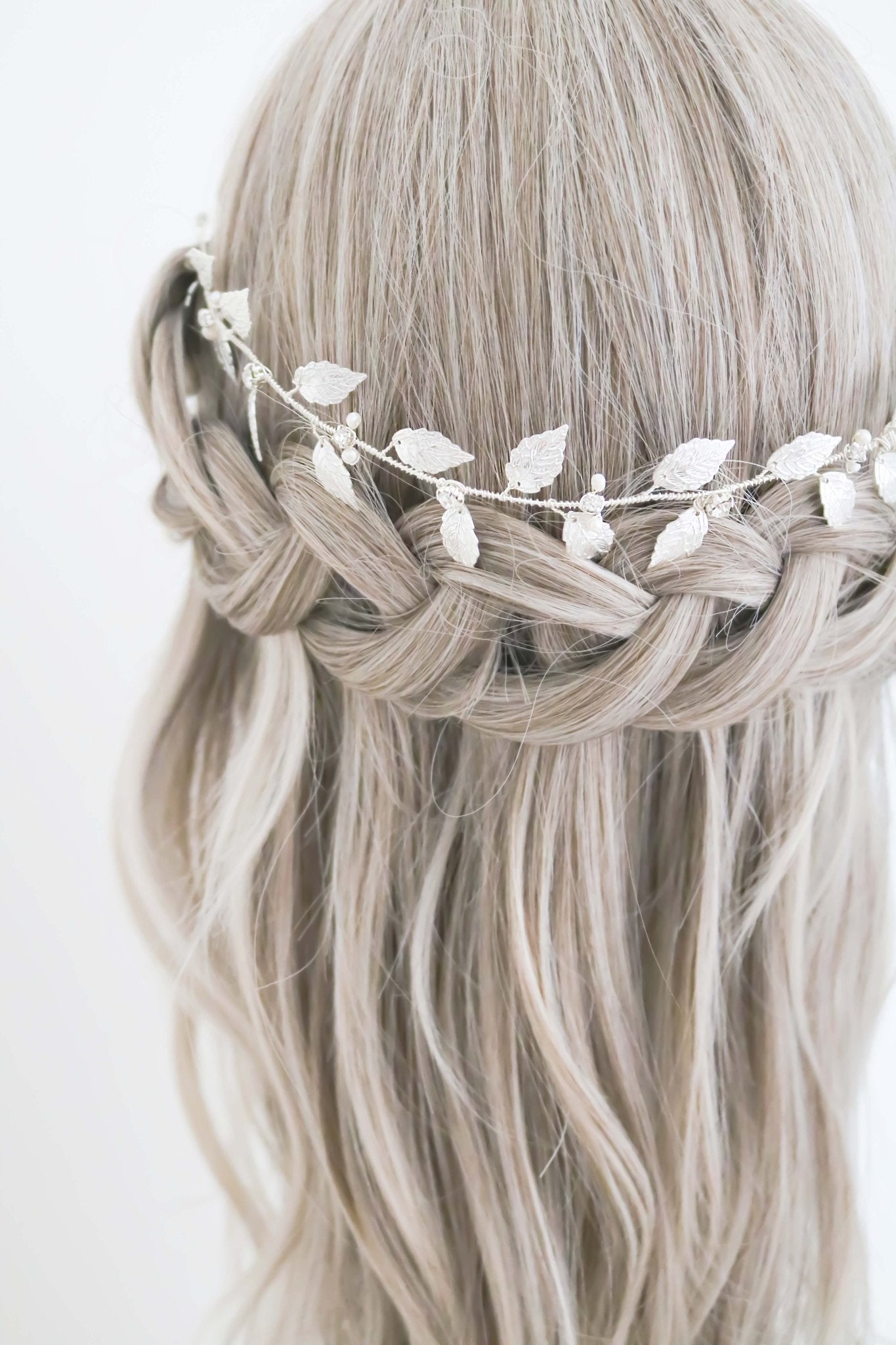 Silver leaf and fresh water pearl crystal bridal hair circlet atop an ashy blonde bridal braid on white background. Silver bridal accessories, bridal hair accessories, & handmade hair accessories Canada