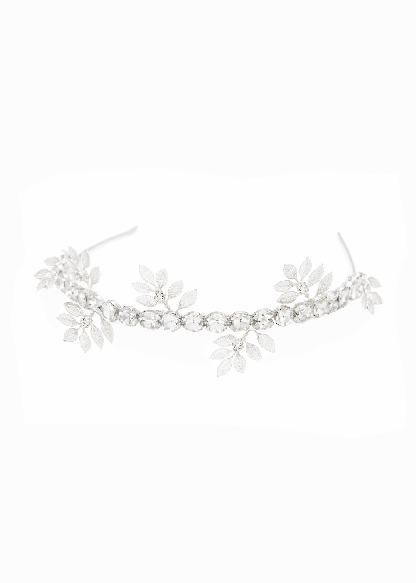 A silver crystal bridal headband with leaf embellishments on white background. Bridal hair accessories & silver wedding accessories handmade in Canada by BIPOC bridal designer