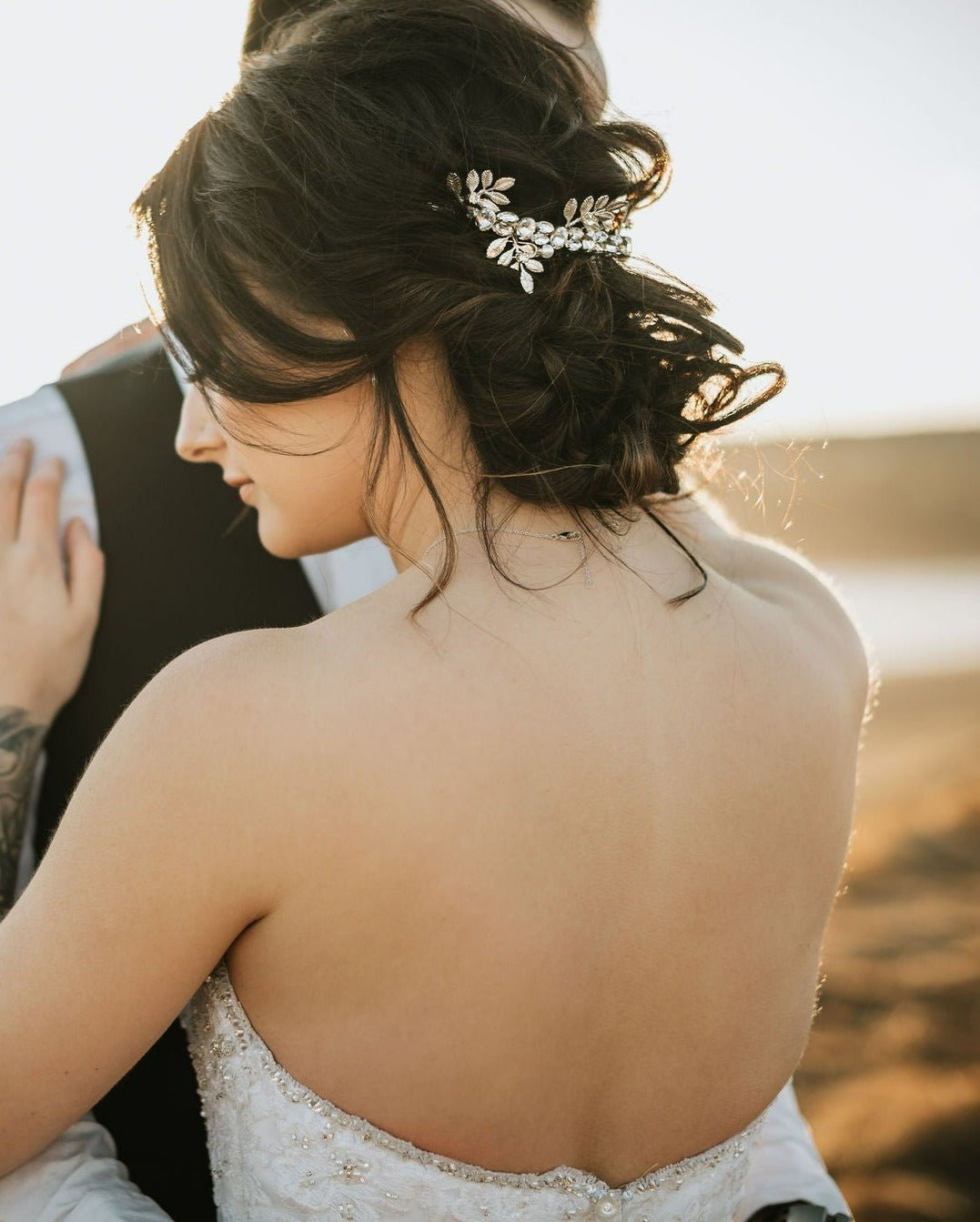 A blissful embrace between newlyweds. Striking bridal hair accessory silver crown with crystals. Bridal Hair Accessories. Bridal Accessories. Canadian Bridal Accessories. Handmade Canadian Accessories. Canadian handmade Accessories. Canadian weddings. Wedding Canada.