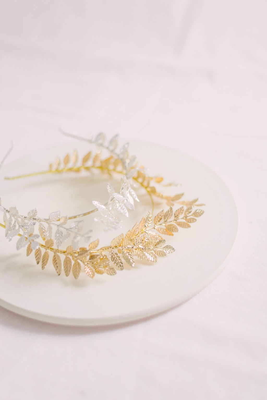 Two Goddess laurel leaf bridal crowns in silver and gold. Bridal Hair Accessories. Bridal Accessories. Canadian Bridal Accessories. Handmade Canadian Accessories. Canadian handmade Accessories. Canadian weddings. Wedding Canada.