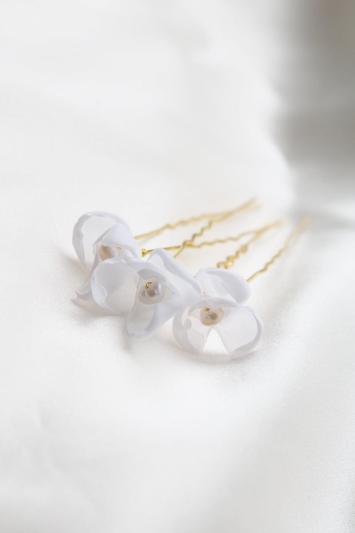 Three Gold Mini Averie Floral Hairpins with freshwater pearl on satin sheet. Canadian bridal jewelry
Woman-owned Canadian jewelry brand. Canadian jewelry business.
Organic pearl jewelry. Bridal jewelry Canada. Pearl jewelry Canada. Pearl Bridal jewelry Canada.