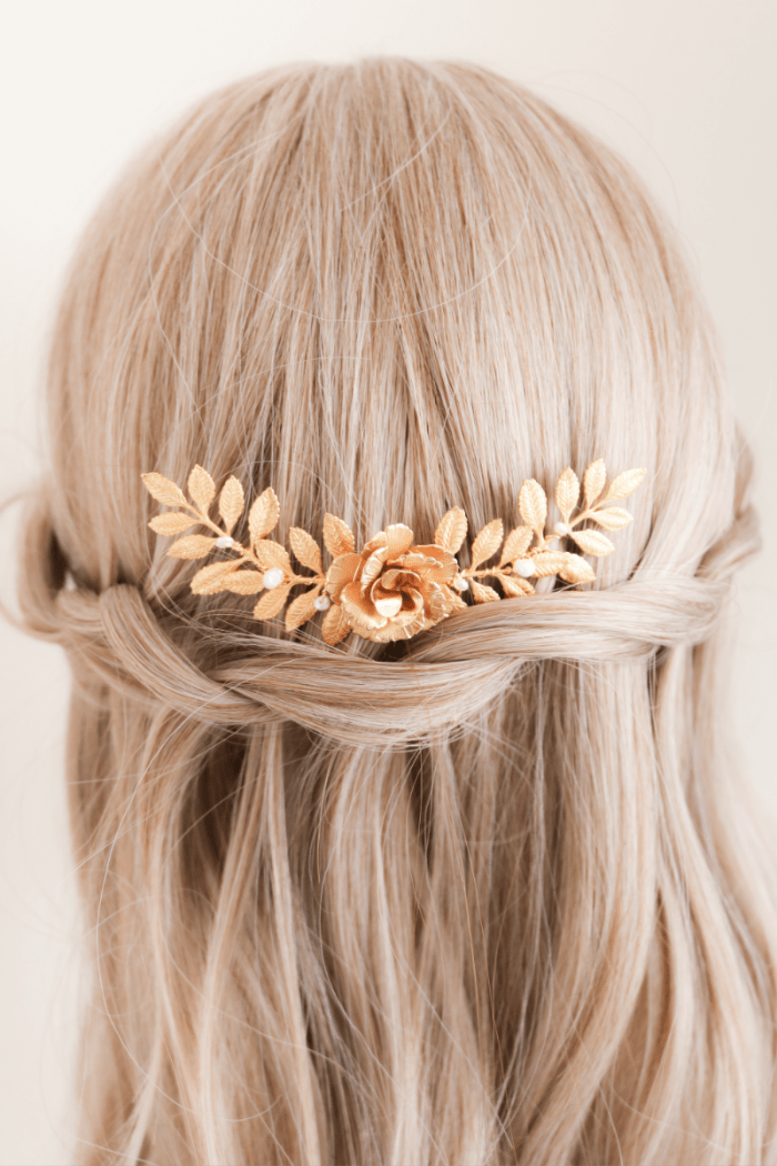 Gold floral bridal hair accessory on blonde hair against a neutral background. Bridal hair accessories & handmade Canadian accessories by a small woman-owned jewelry brand
