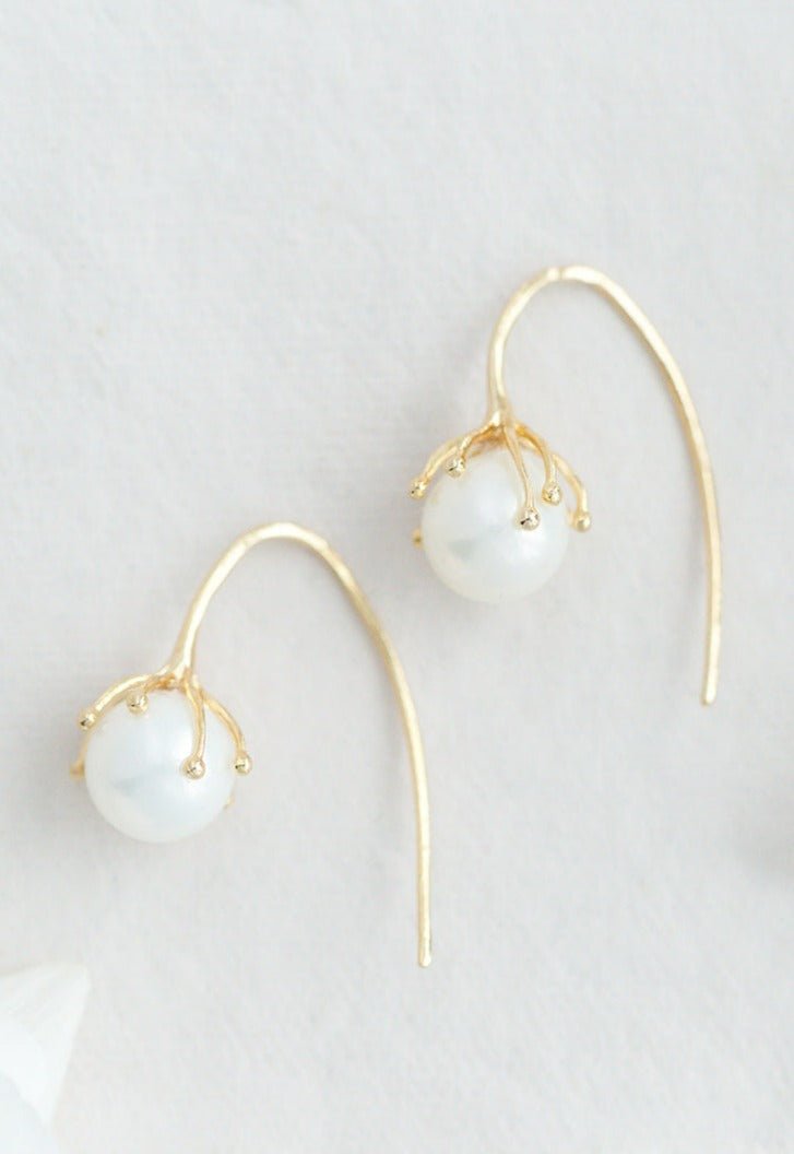 A pair of gold-filled freshwater pearl flower bud bridal earrings on white background. Pearl jewelry Canada. Pearl Bridal jewelry Canada