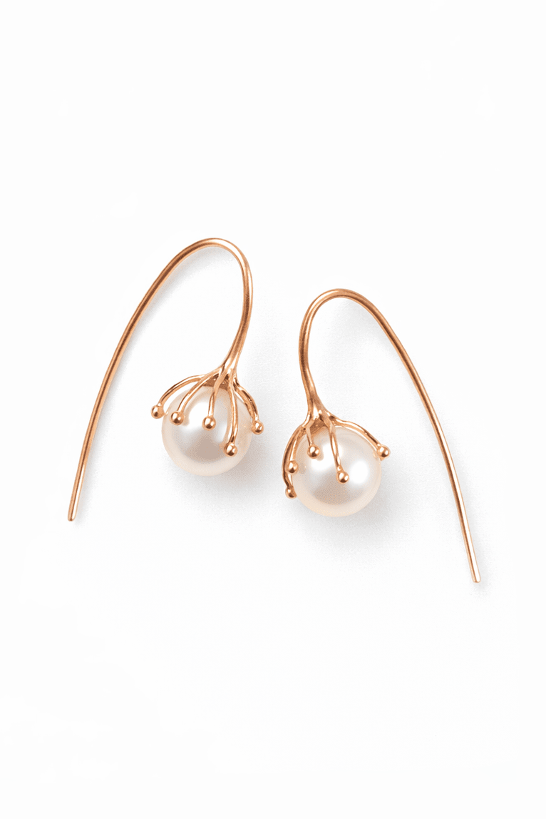 Pair of freshwater pearl bridal earrings with rose gold hooks on a white background. Organic pearl jewelry & freshwater pearl jewelry handmade by a Canadian jewelry artist