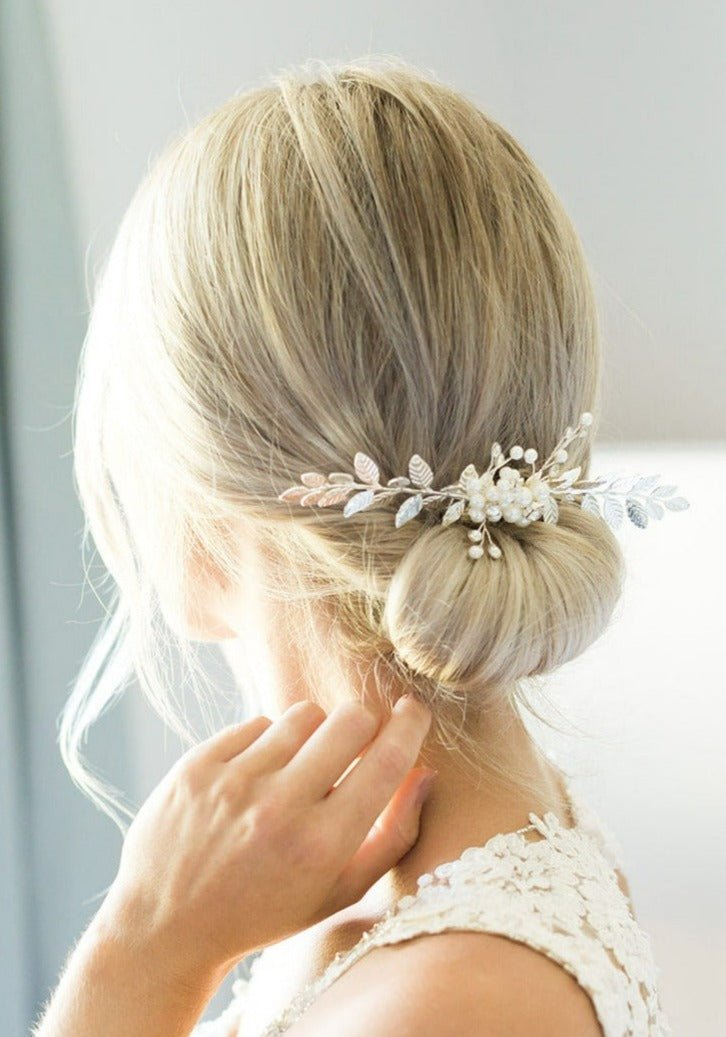 Silver bridal hair comb with crystals, pearls, & leafy design sitting in a blonde bridal hairstyle. Bridal hair accessories & Canadian bridal accessories handmade by Canadian bridal designer
