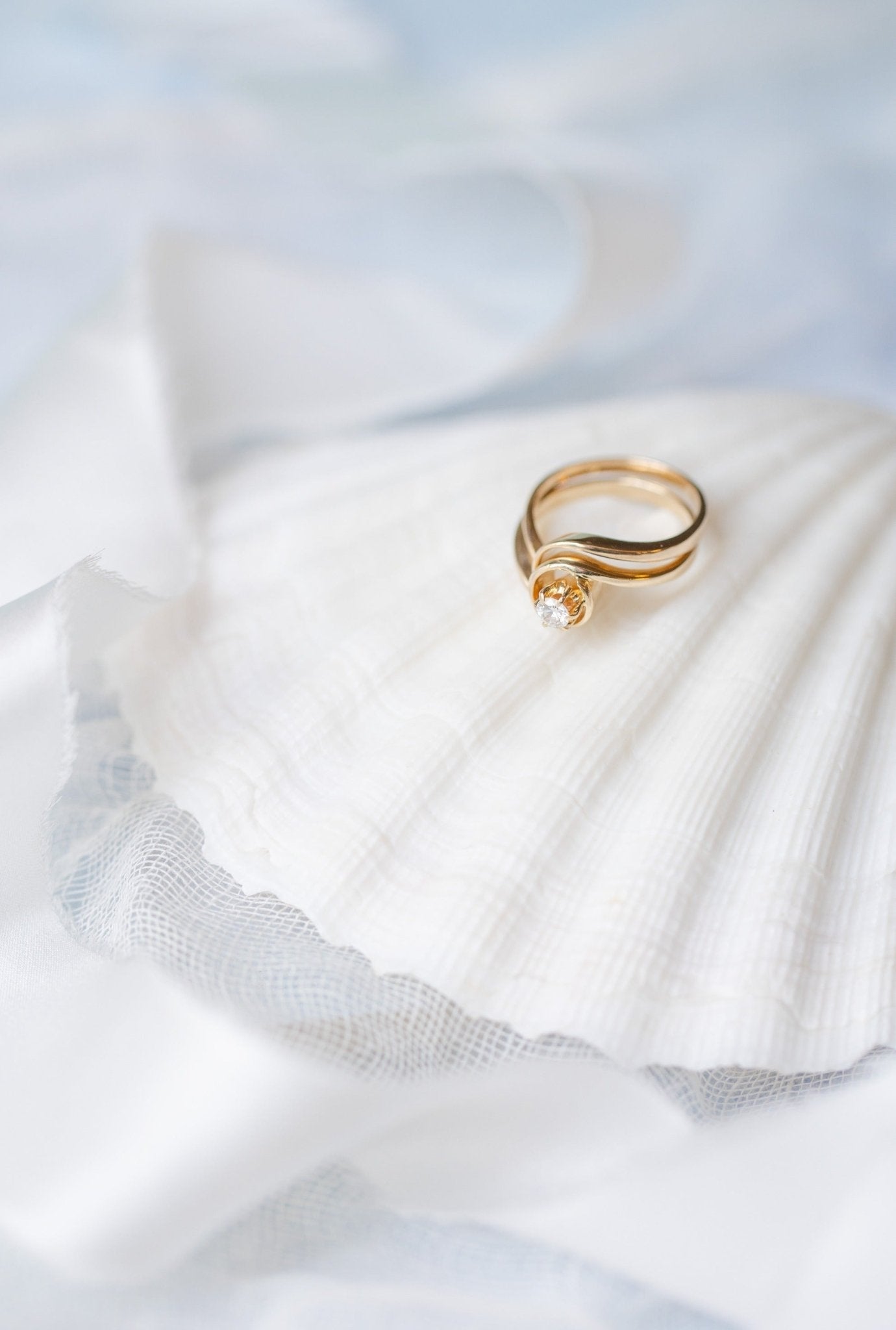 The Clara Vintage Solitaire Diamond Engagement Ring in 14k Gold sits on top of a large seashell. Antique Engagement Rings Canada. Canadian vintage engagement rings. Vintage engagement rings Canada. Bridal jewelry Canada. Canadian weddings. Wedding Canada. Canadian bridal jewelry. Woman-owned Canadian jewelry brand. Canadian jewelry business.