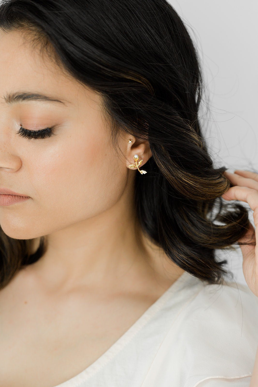 Gold-filled freshwater pearl floral earring on ear. Organic pearl jewelry. Bridal jewelry Canada. Pearl jewelry Canada.