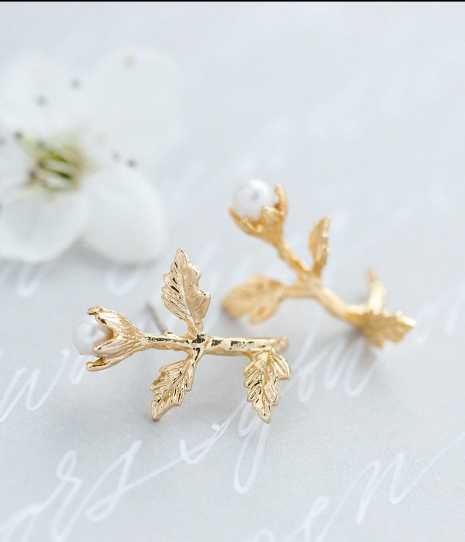 A close up view of a pair of Gold-filled Dancer Pearl & Flower Studs. Pearl jewelry Canada. Pearl Bridal jewelry Canada. Gold-filled jewelry Canada. Handmade Canadian jewelry. Organic pearl jewelry.