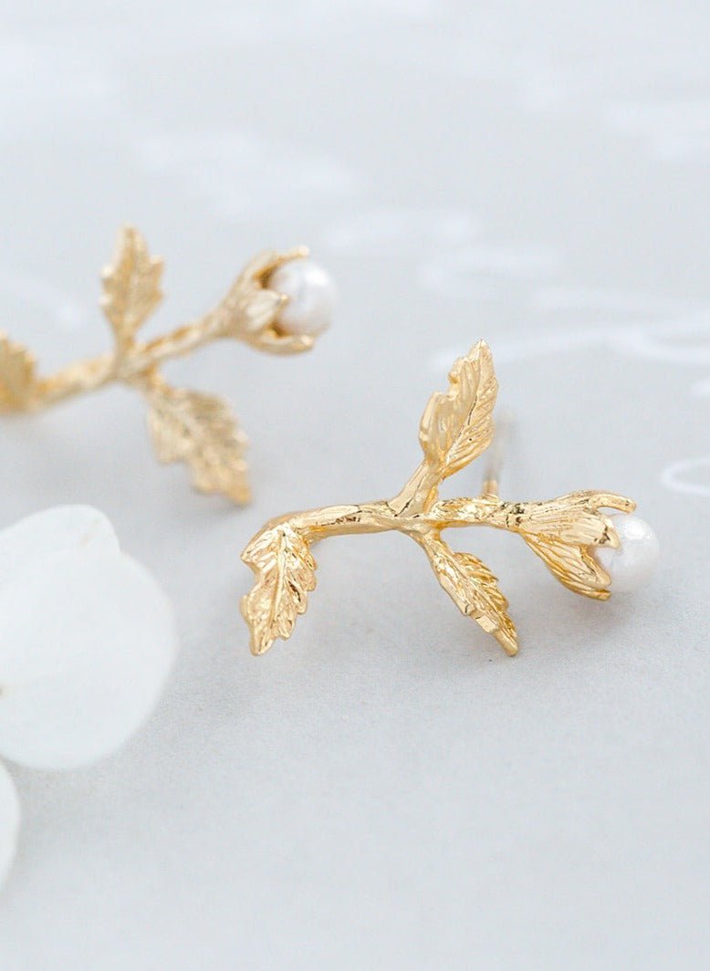 A close up view of a pair of Gold-filled Dancer Freshwater Pearl & Flower Bridal Studs. Bridal jewelry Canada. Pearl jewelry Canada. Pearl Bridal jewelry Canada. Gold-filled jewelry Canada. Gold-filled Canadian jewelry. Handmade Canadian jewelry. Canadian handmade jewelry. Small Canadian jewelry brands. Canadian jewelry brands.