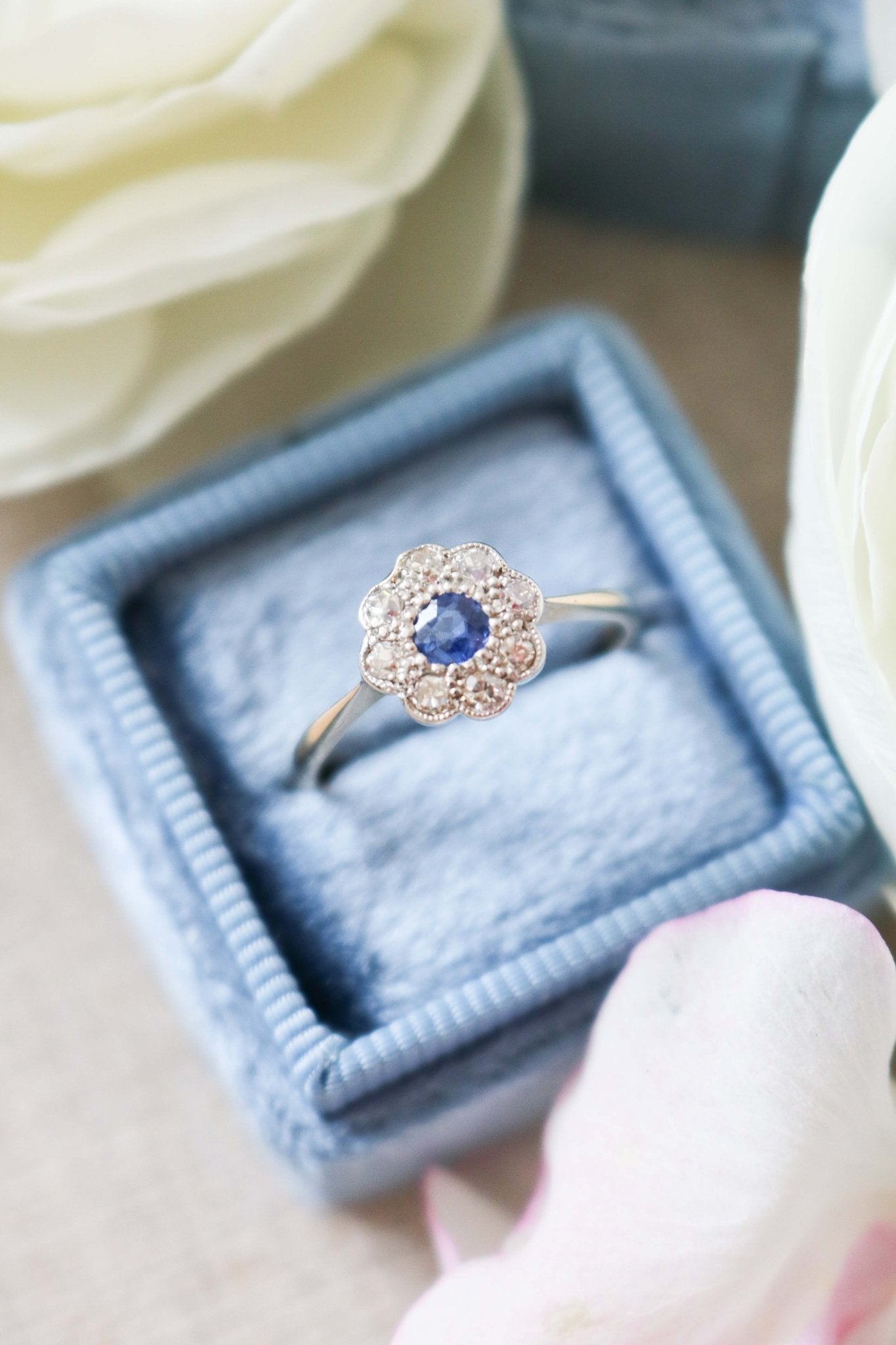 A close up top view of a 18k Yellow and White Gold Vintage Sapphire and Diamond Engagement Ring on top of a powder blue ring box. Canadian vintage engagement rings. Bridal jewelry Canada. Canadian weddings. Wedding Canada. Canadian bridal jewelry. Woman-owned Canadian jewelry brand. Canadian jewelry brands.