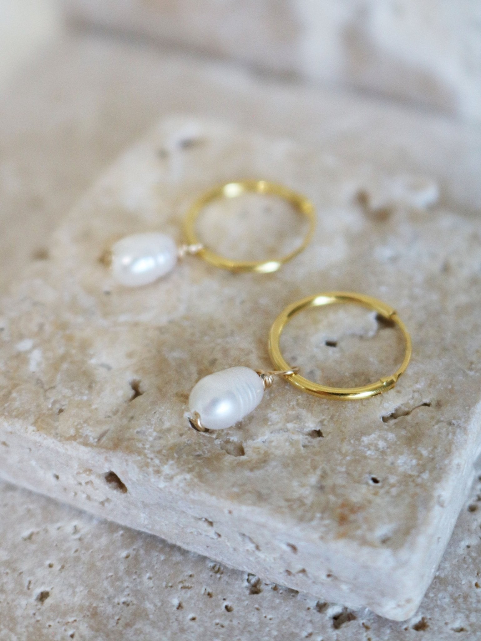 Dew Drop Fresh Water Pearl Hoops Displayed on Stone. Bridal jewelry Canada. Pearl jewelry Canada. Pearl Bridal jewelry Canada. Gold-filled jewelry Canada. Minimalist Bridal Jewelry. Canadian jewelry business. Organic pearl jewelry. Canadian handmade jewelry.