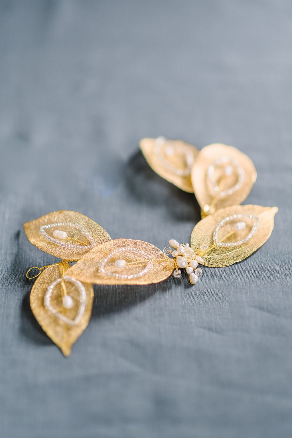 Diana Fresh Water Pearl and Crystal Bridal Hairpiece on a greyish-blue fabric background. Bridal Hair Accessories. Bridal Accessories. Canadian Bridal Accessories. Handmade Canadian Accessories. Canadian handmade Accessories. Canadian weddings. Wedding Canada. Organic pearl accessories. Pearl Bridal Hair Accessories. Pearl Bridal Accessories.