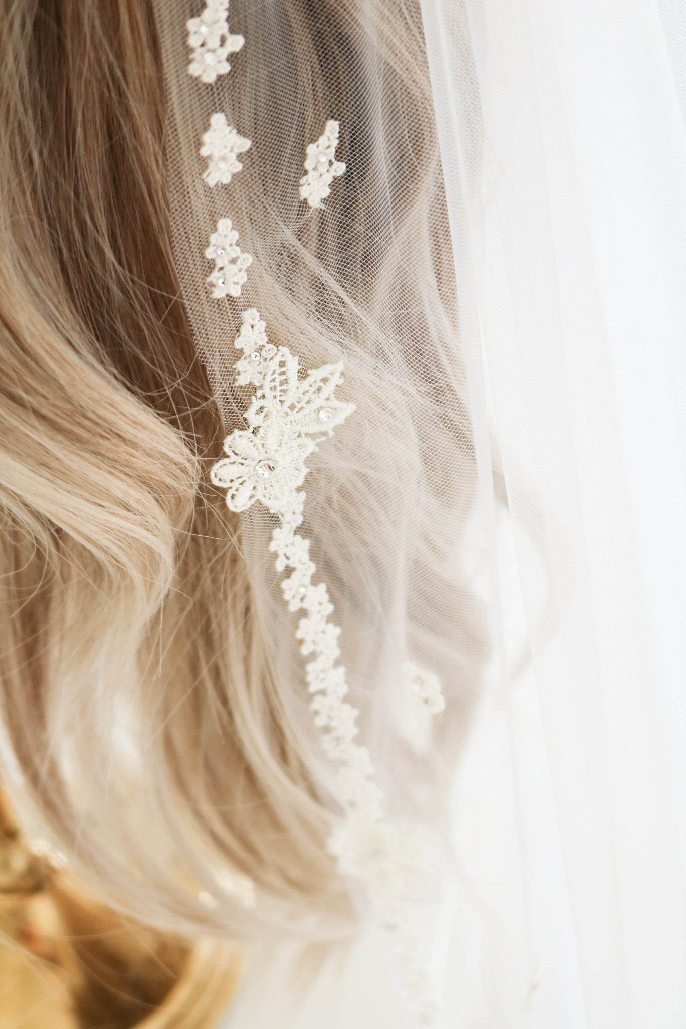 A close-up of the Eislyn Floral Wedding Veil in Off-white and Ivory. Canadian weddings. Wedding Canada. Wedding veils Canada. Bridal Hair Accessories. Bridal Accessories. Canadian Bridal Accessories. Handmade Canadian Accessories. Canadian handmade Accessories. Canadian designer. Canadian artist.