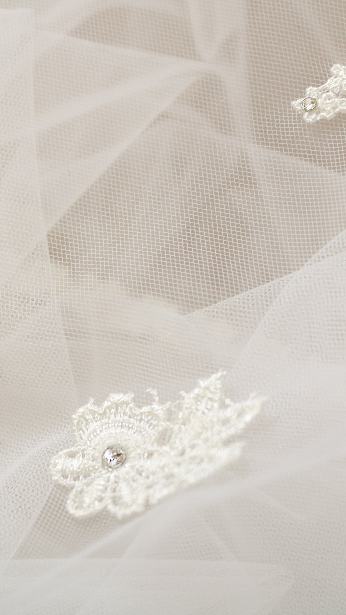 Extreme close up of a detailed embroidered lace flower on sheer tulle wedding veil. Canadian weddings. Wedding Canada. Wedding veils Canada. Bridal Hair Accessories. Bridal Accessories. Canadian Bridal Accessories. Handmade Canadian Accessories. Canadian handmade Accessories. Canadian designer. Canadian artist.