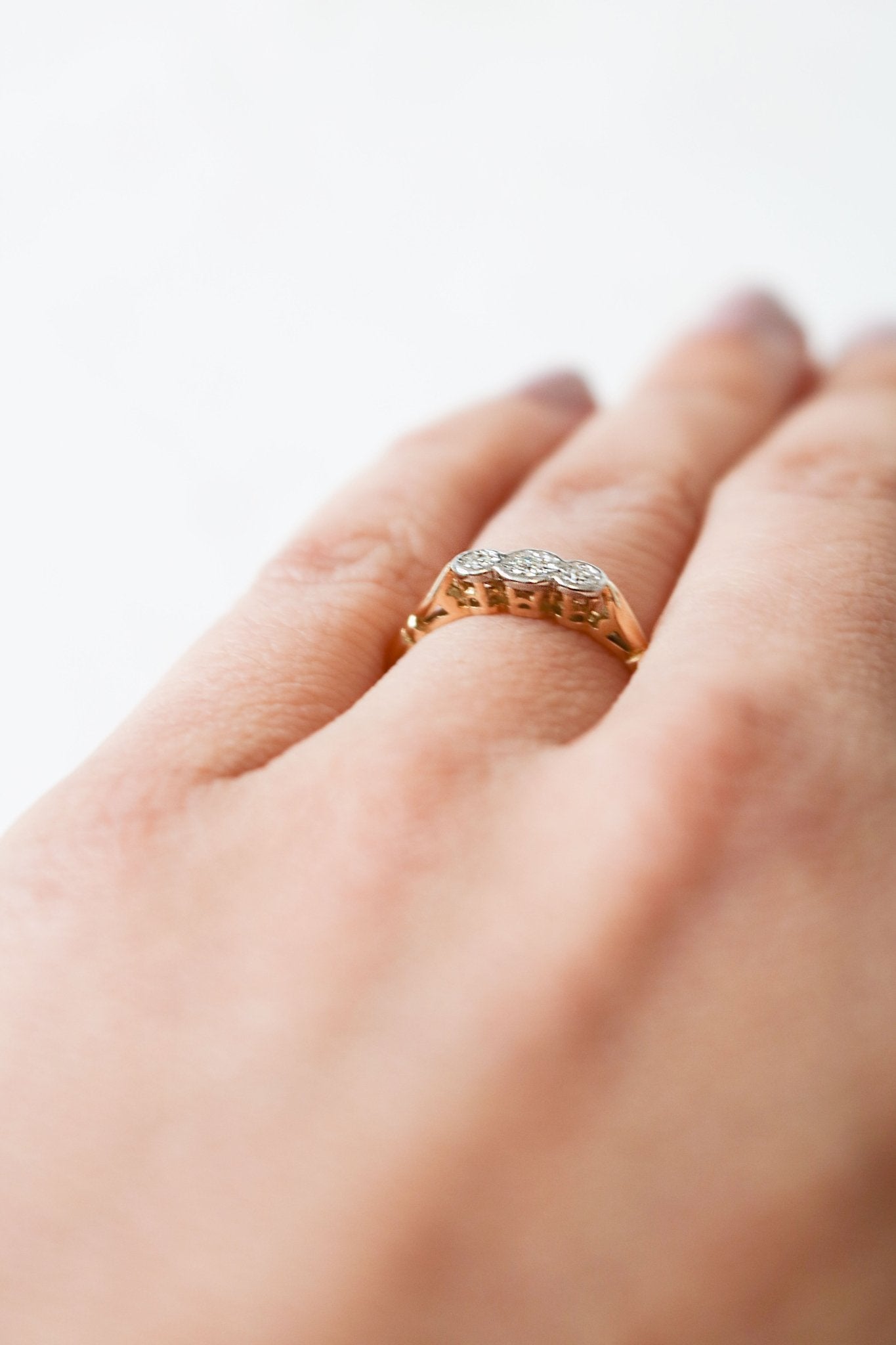 A close up side view of an 18ct Gold and Three Diamond Vintage Engagement Ring sits on a ring finger. Antique Engagement Rings Canada. Canadian vintage engagement rings. Vintage engagement rings Canada. Bridal jewelry Canada. Canadian bridal jewelry. Woman-owned Canadian jewelry brand. Canadian jewelry business. Canadian weddings.