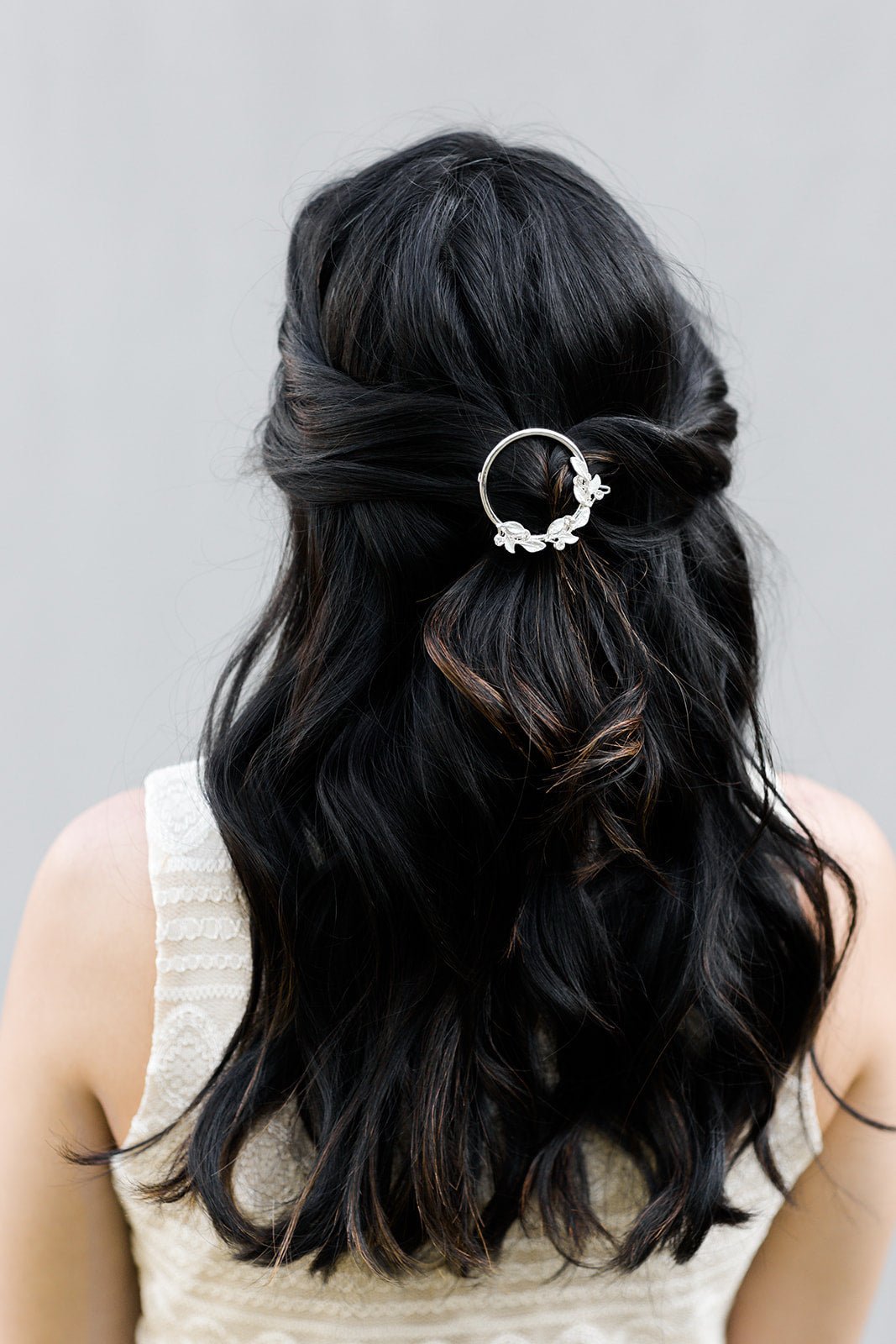 Silver round leaf crystal bridal barrette clipped in long dark hair. Silver bridal hair accessories good for everyday wear handmade by Canadian jewelry business