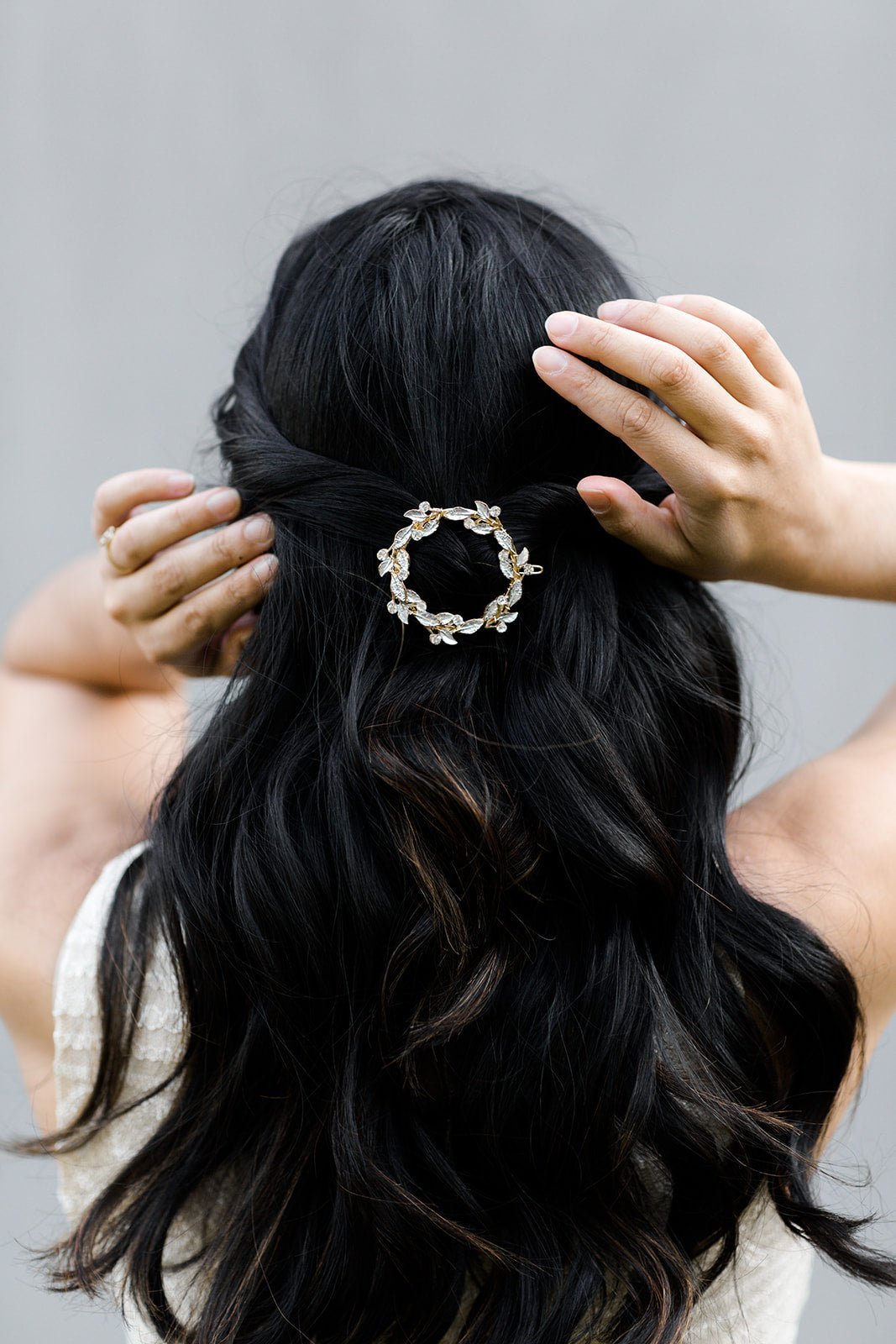 Golden crystal and leaf full bridal barrette holding long curled dark hair. from the back. Handmade Canadian accessories & bridal hair accessories good for everyday wear and weddings