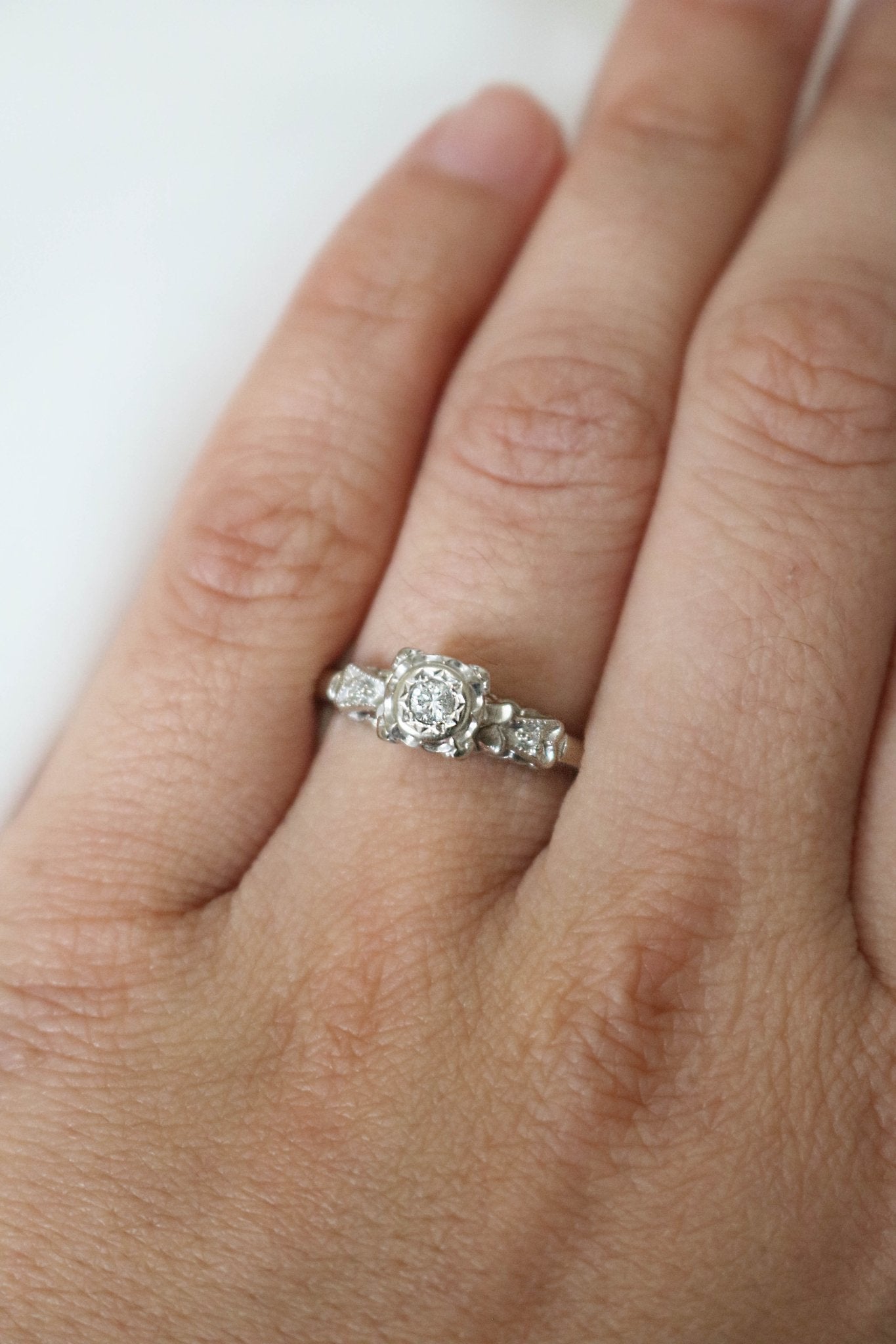 A 14k White Gold Vintage Diamond Engagement Ring on a ring finger. Canadian vintage engagement rings. Bridal jewelry Canada. Wedding Canada. Small Canadian jewelry brands. Canadian bridal jewelry. Woman-owned Canadian jewelry brand. Canadian jewelry business. Antique Engagement Ring.
