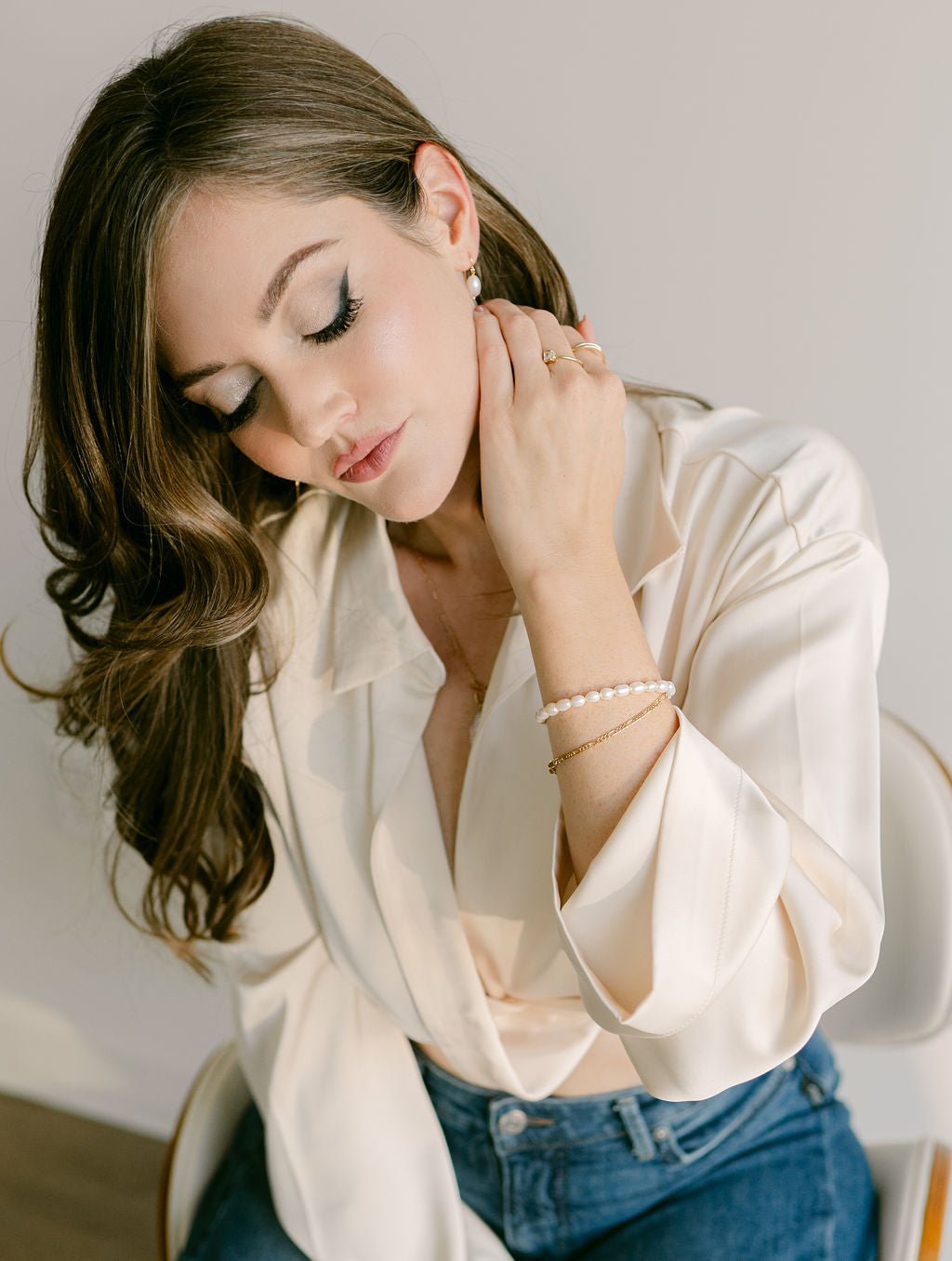 Woman with gold-filled Figaro bracelet and organic freshwater pearl bracelet. Everyday jewelry Canada.