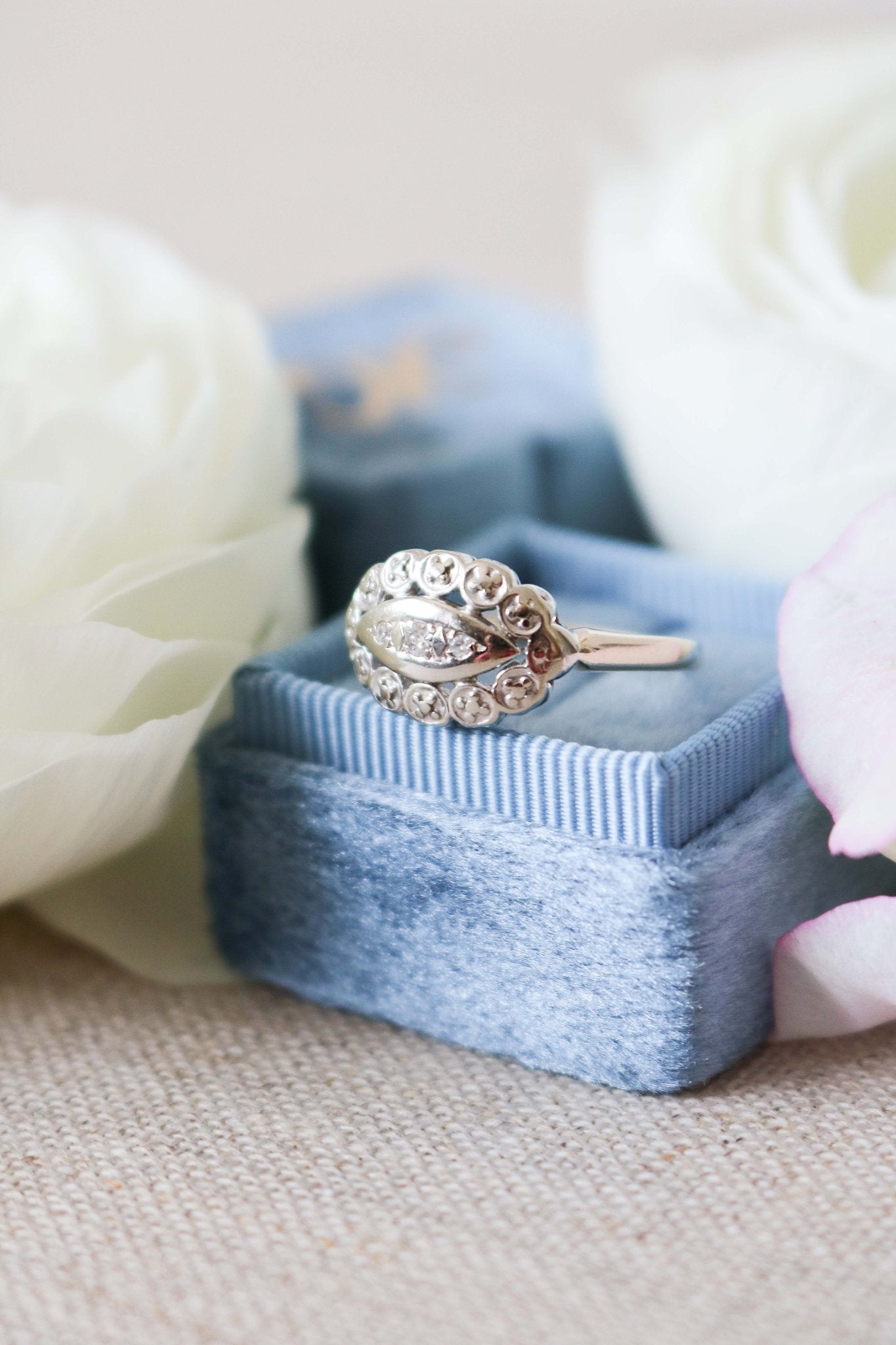 Diamond and 14ct Gold Art Deco Style front view of vintage engagement ring on a ring box with white roses. Canadian jewelry business. Antique Engagement Rings Canada. Canadian vintage engagement rings. Vintage engagement rings Canada. Bridal jewelry Canada. Canadian weddings. Wedding Canada. Canadian bridal jewelry. Woman-owned Canadian jewelry brand.