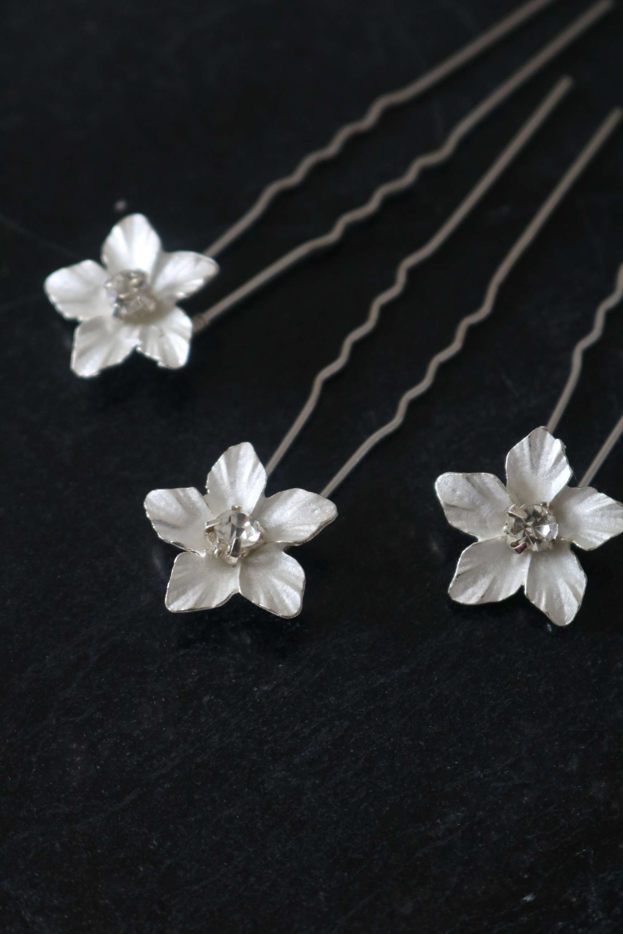 Three Silver Feya Crystal Flower Hairpins on a dark background. Canadian jewelry designer. Bridal jewelry Canada. Sterling Silver jewelry Canada. Canadian jewelry brands. Affordable Canadian jewelry brands. Handmade Canadian jewelry.