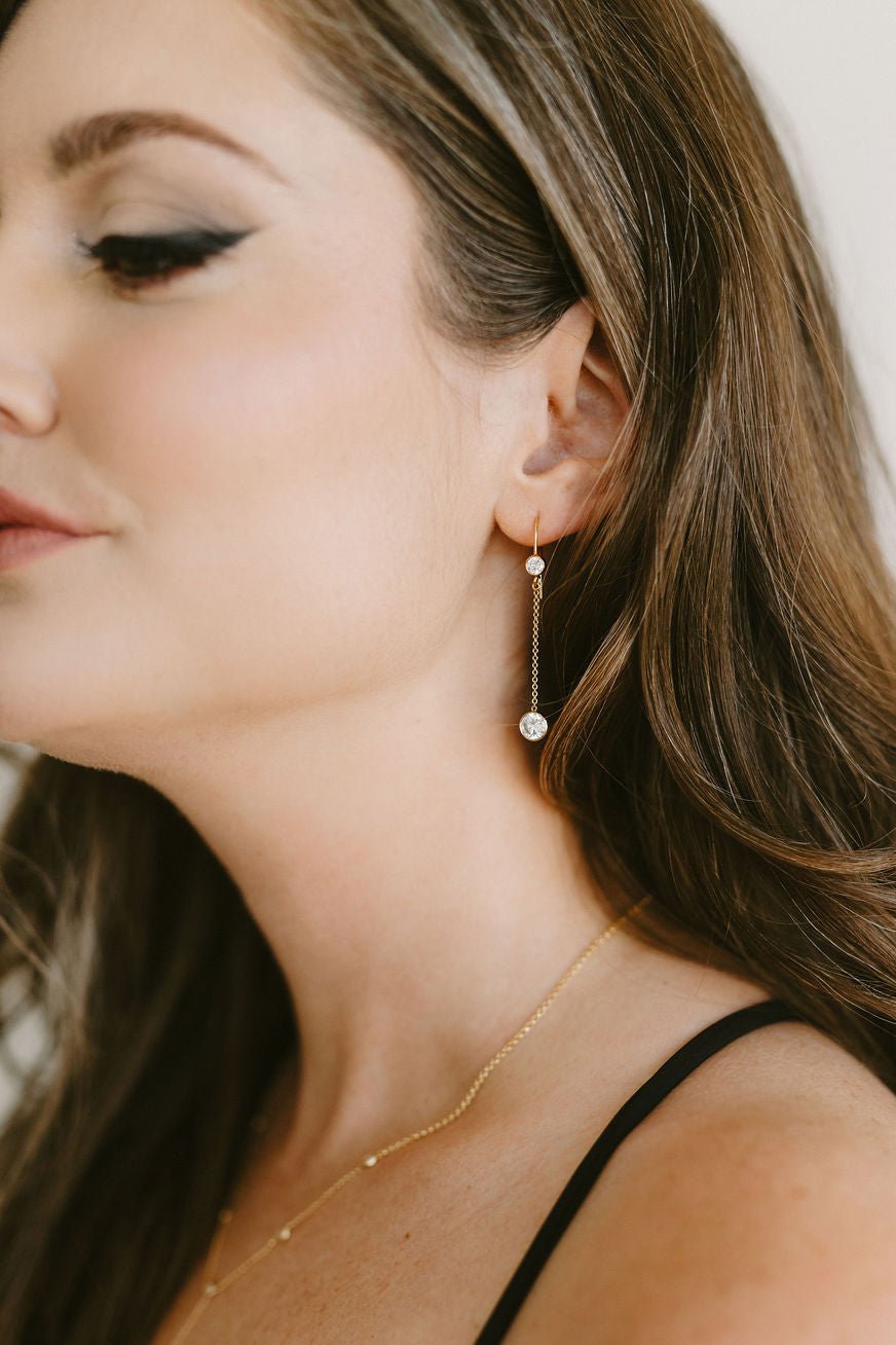 Woman with gold-filled crystal drop earrings and matching lariat style necklace. Canadian handmade jewelry. Minimal bridal jewelry.