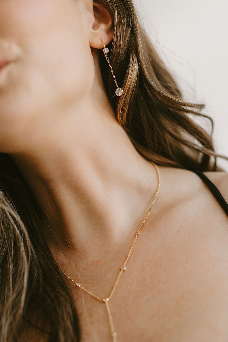 A matching set of Gemini drop crystal earrings and gold crystal lariat necklace. Canadian jewelry designer. Minimalist Jewelry.