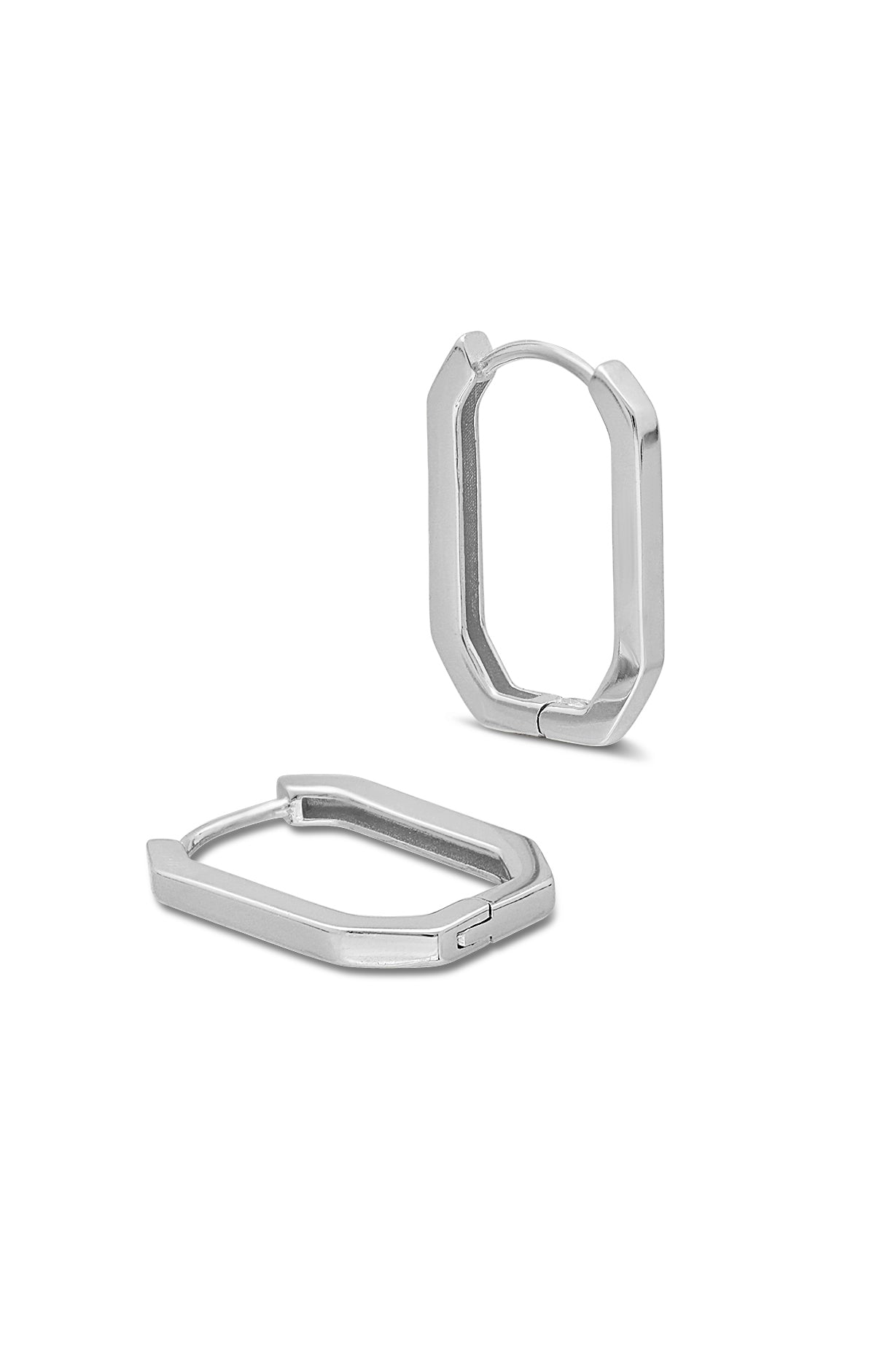 Pair of sterling silver huggie hoop earrings on a white background. Minimalist jewelry. Modern jewelry Canada. Canadian jewelry brands.