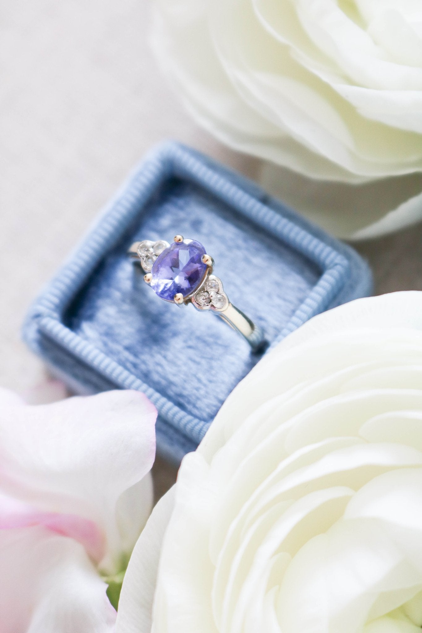 A close up of the Jolie Violet Tanzanite and White Topaz Vintage Engagement Ring in 9ct Gold sitting in a ring box surrounded by white roses. Antique Engagement Rings Canada. Canadian vintage engagement rings. Vintage engagement rings Canada. Bridal jewelry Canada. Wedding Canada. Canadian bridal jewelry
Woman-owned Canadian jewelry brand. Small Canadian jewelry brands.