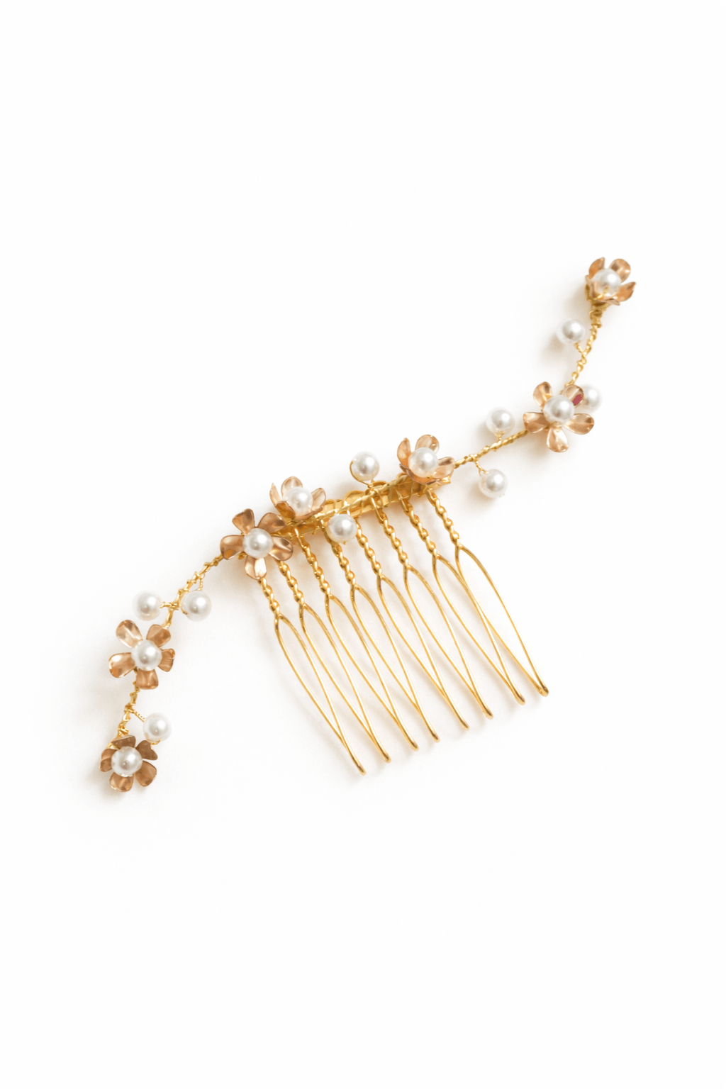Gold bridal hair comb with floral and pearl decorations on a white background. Canadian bridal accessories & bridal hair accessories handmade by BIPOC wedding designer