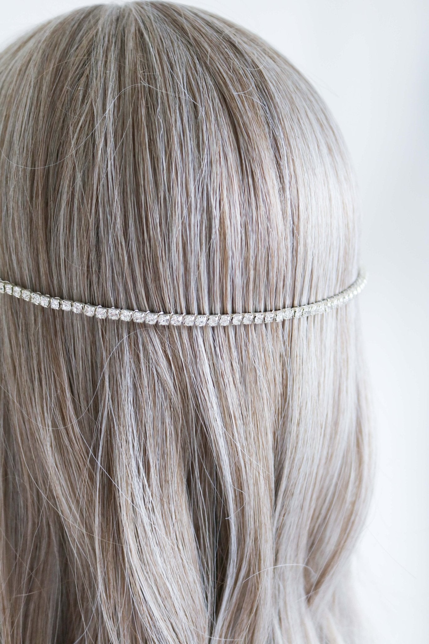 A Libra crystal halo headband in silver set in the back of a bridal hairstyle. Bridal Hair Accessories. Bridal Accessories. Canadian Bridal Accessories. Handmade Canadian Accessories. Canadian handmade Accessories. Canadian weddings. Wedding Canada. Canadian designer. Canadian artist.