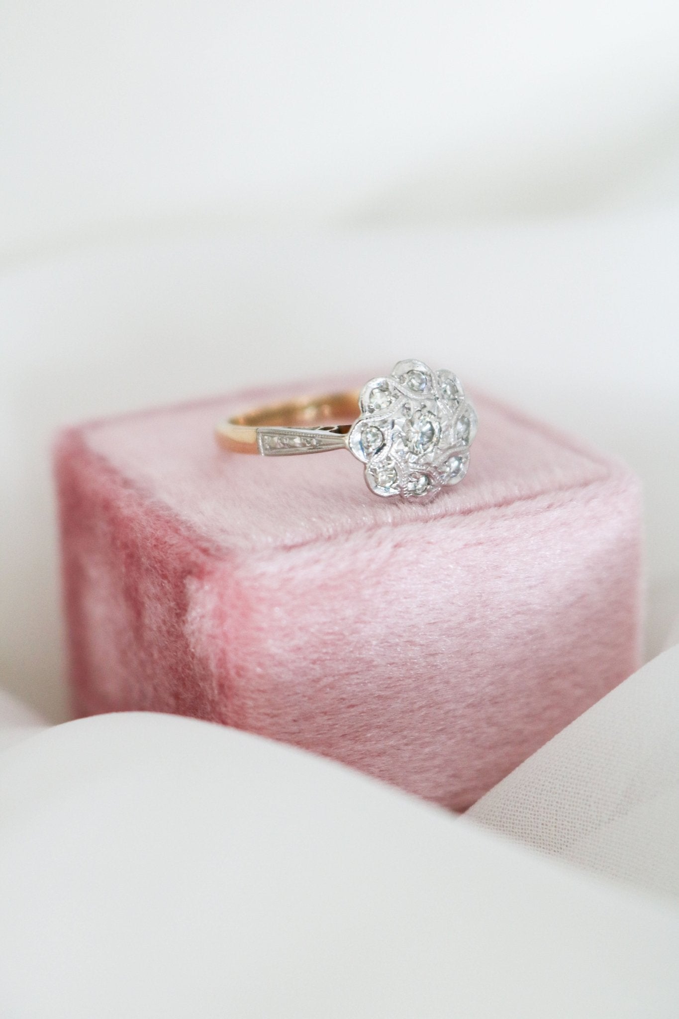 Side view of the Lilibet Diamond Vintage Engagement Ring in 18k Yellow Gold and Platinum, Art Deco Style from the 1930s on top of ring box. Canadian vintage engagement rings. Bridal jewelry Canada. Vintage engagement rings Canada. Canadian weddings. Wedding Canada. Woman-owned Canadian jewelry brand. Canadian jewelry business. Small Canadian jewelry brands.