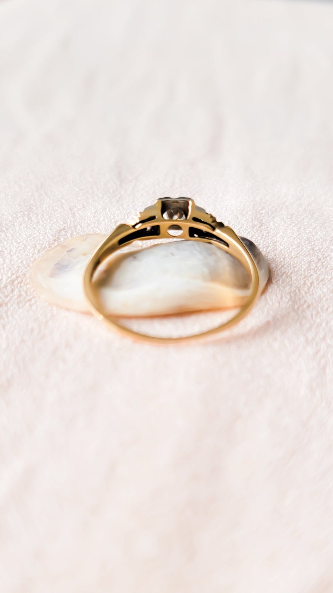 Back view of the Lisbet Vintage Diamond Engagement Ring on top of a seashell. Antique Engagement Rings Canada. Canadian vintage engagement rings. Vintage engagement rings Canada. Bridal jewelry Canada. Canadian bridal jewelry. Woman-owned Canadian jewelry brand. Canadian jewelry business. Canadian weddings.