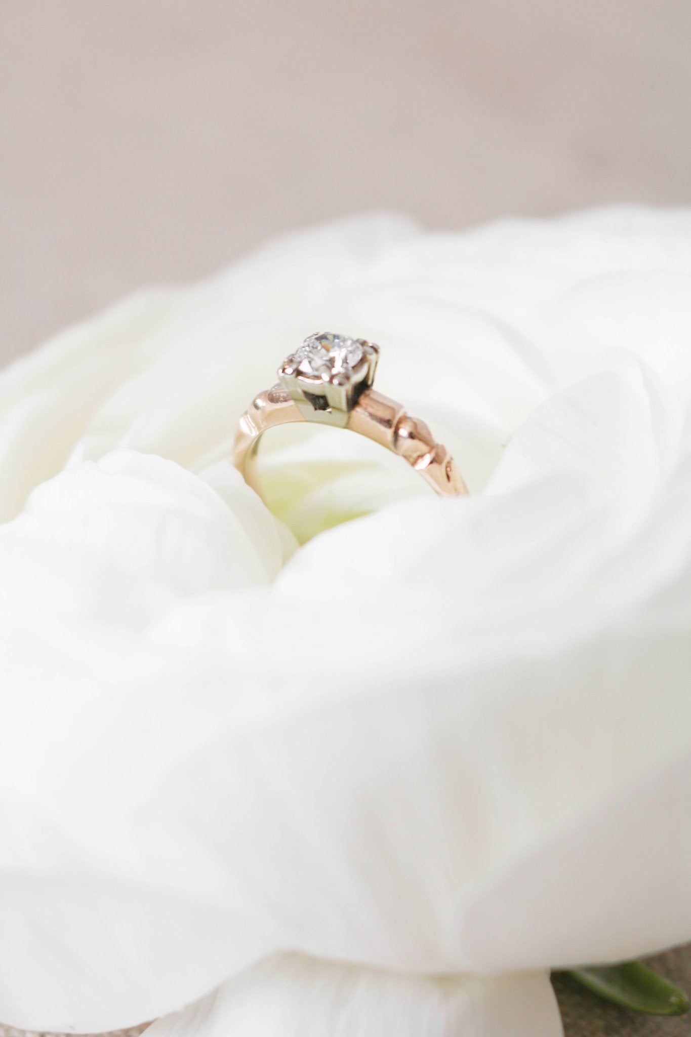 Side view of the Lise Diamond Solitaire Engagement Ring in 14ct Gold nestled in a white rose. Antique Engagement Rings Canada. Canadian vintage engagement rings. Vintage engagement rings Canada. Bridal jewelry Canada. Canadian weddings. Wedding Canada. Canadian bridal jewelry. Woman-owned Canadian jewelry brand. Canadian jewelry business.