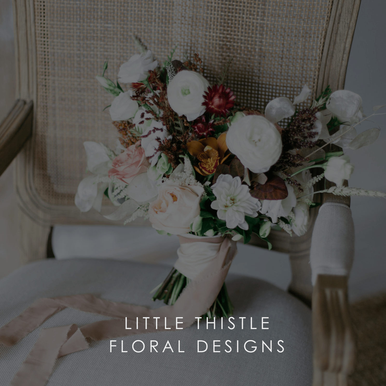 A bridal bouquet of pink and white roses on an old chair.