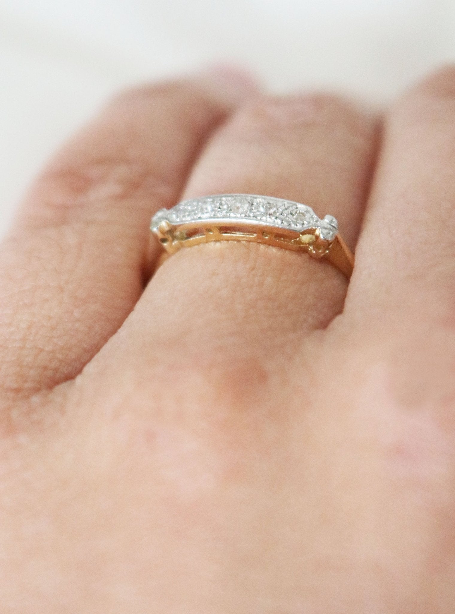 Side view of a yellow and white gold diamond vintage engagement ring/wedding band on a ring finger. Canadian vintage engagement rings. Bridal jewelry Canada. Canadian weddings. Wedding Canada. Small Canadian jewelry brands. Canadian jewelry brands. Affordable Canadian jewelry brands.