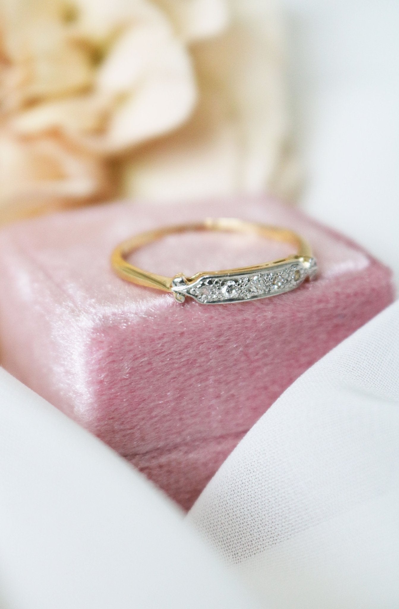The Livie Diamond Vintage Engagement Ring/Wedding Band in 18k Yellow and White Gold sitting atop a ring box. Canadian vintage engagement rings. Bridal jewelry Canada. Canadian weddings. Wedding Canada. Small Canadian jewelry brands. Canadian jewelry brands. Affordable Canadian jewelry brands.