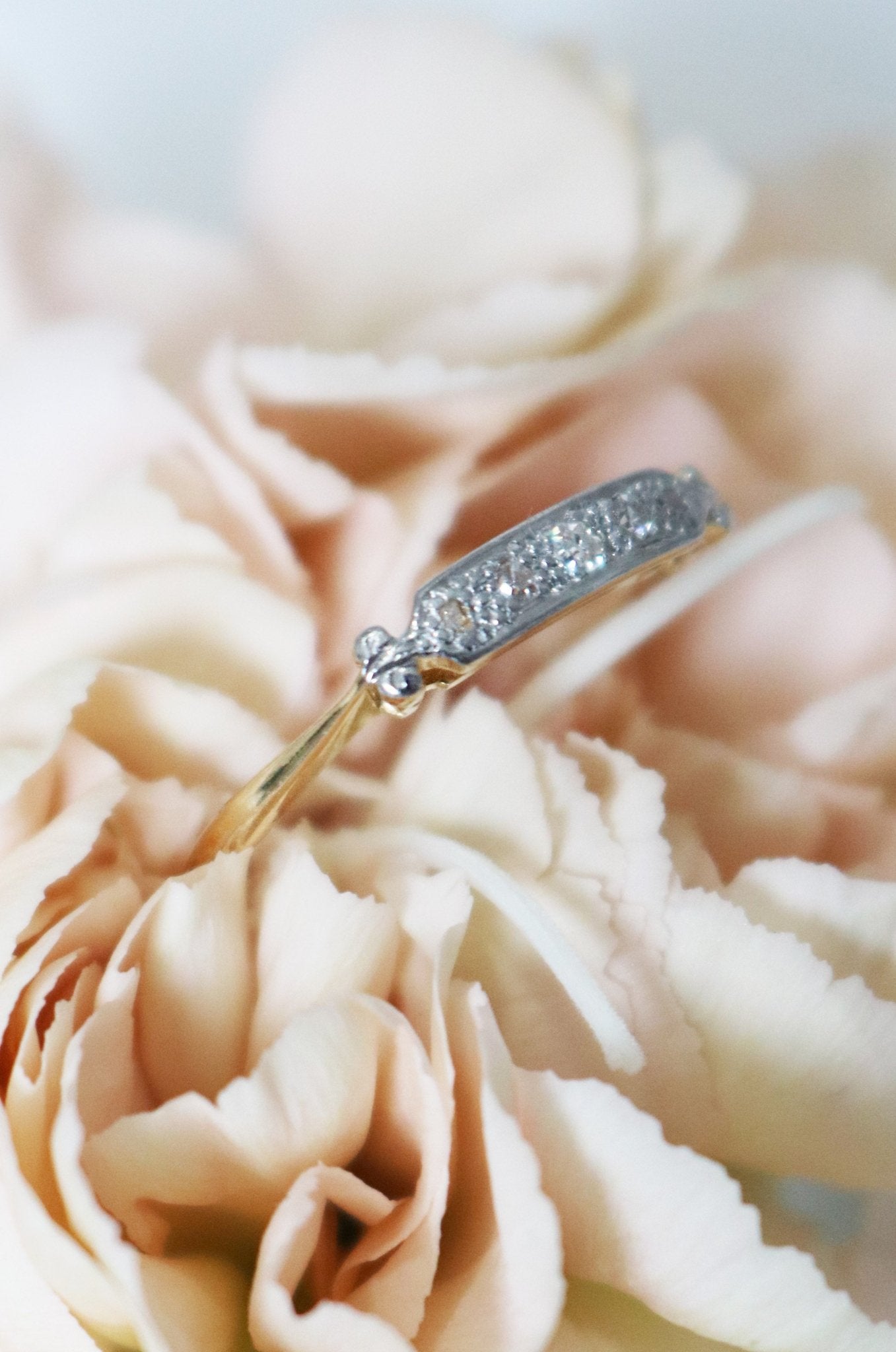Side view of a Diamond Vintage Engagement Ring/Wedding Band in 18k Yellow and White Gold nestled in a golden flower. Canadian vintage engagement rings. Bridal jewelry Canada. Canadian weddings. Wedding Canada. Small Canadian jewelry brands. Canadian jewelry brands. Affordable Canadian jewelry brands.