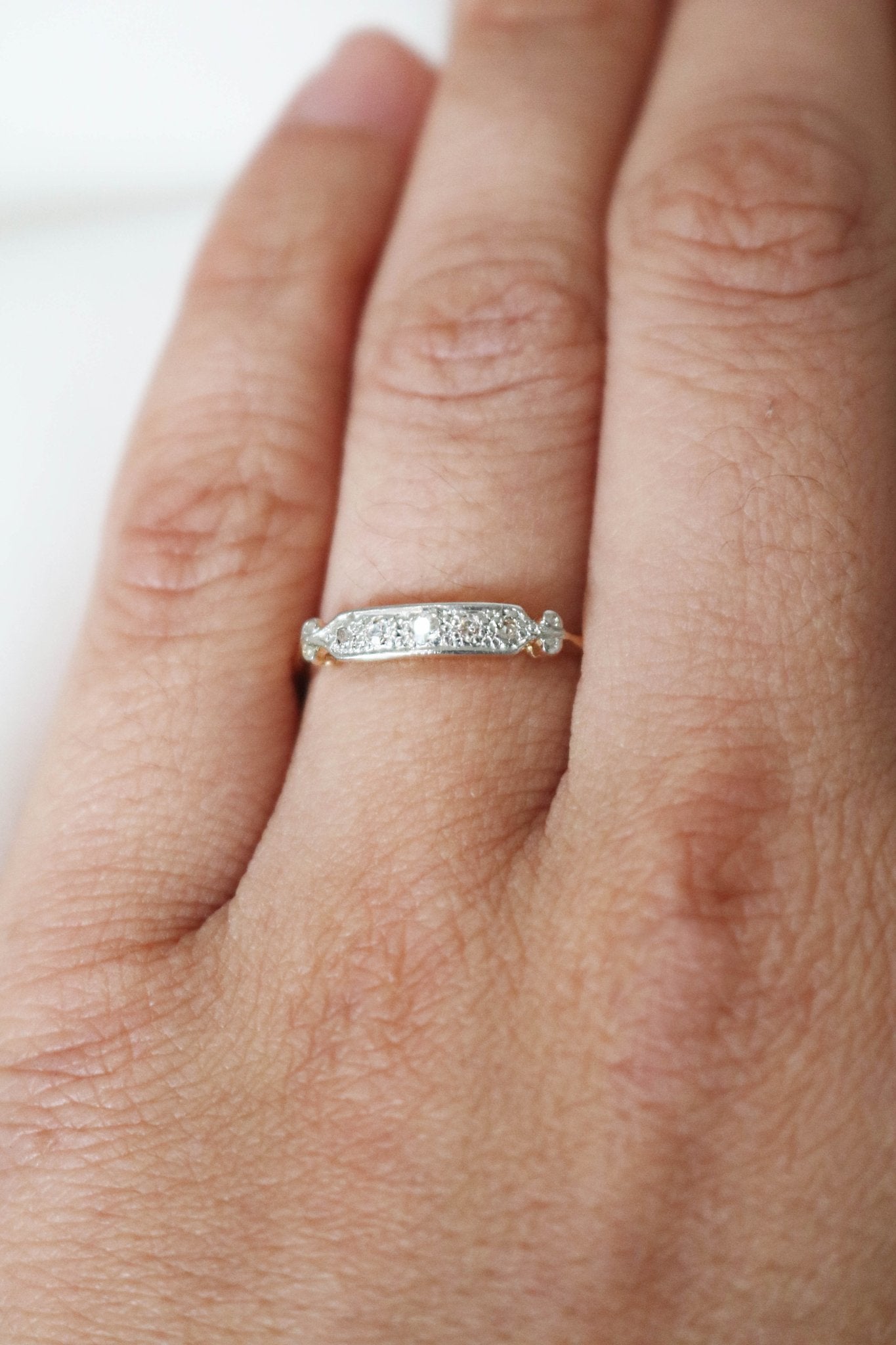 Top view of a yellow and white gold diamond vintage engagement ring/wedding band on a ring finger. Canadian vintage engagement rings. Bridal jewelry Canada. Canadian weddings. Wedding Canada. Small Canadian jewelry brands. Canadian jewelry brands. Affordable Canadian jewelry brands.