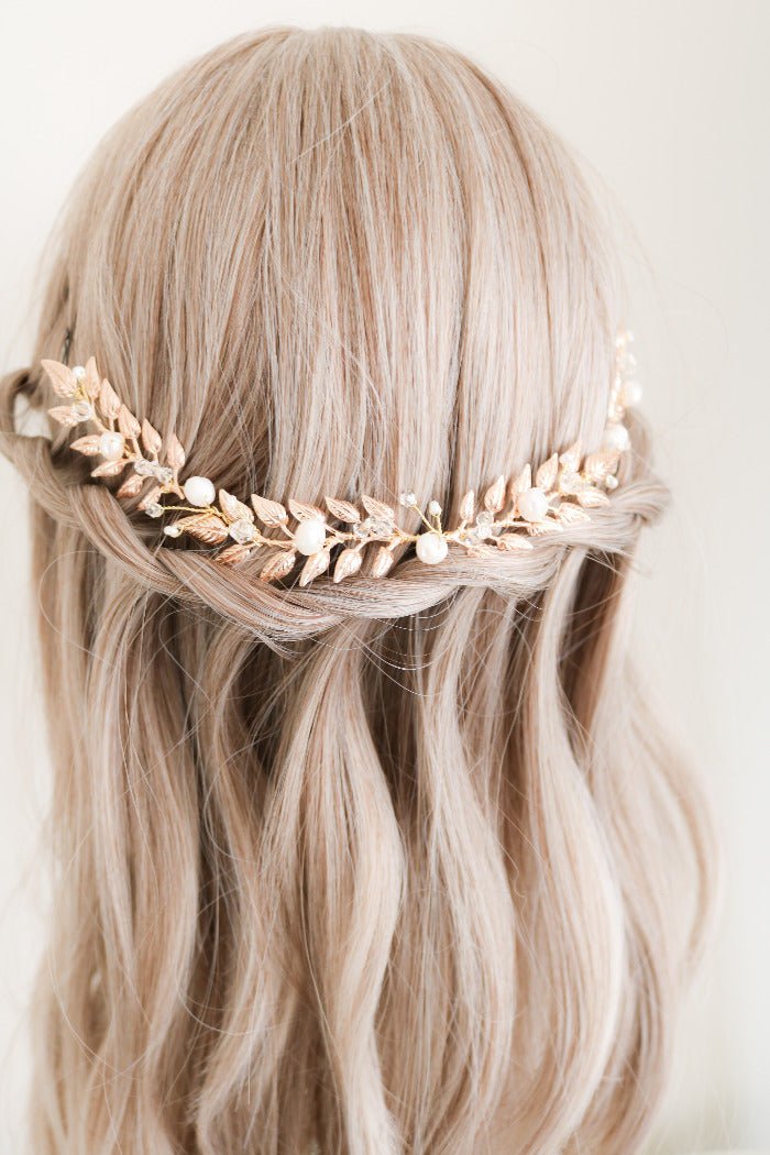 The gold Loriana Laurel Bridal Hairvine with Fresh Water Pearls sitting on the back of a head bust wig over a braid. Organic pearl accessories. Pearl Bridal Hair Accessories. Pearl Bridal Accessories. Bridal Hair Accessories. Bridal Accessories. Canadian Bridal Accessories. Handmade Canadian Accessories. Canadian handmade Accessories. Canadian weddings. Wedding Canada.