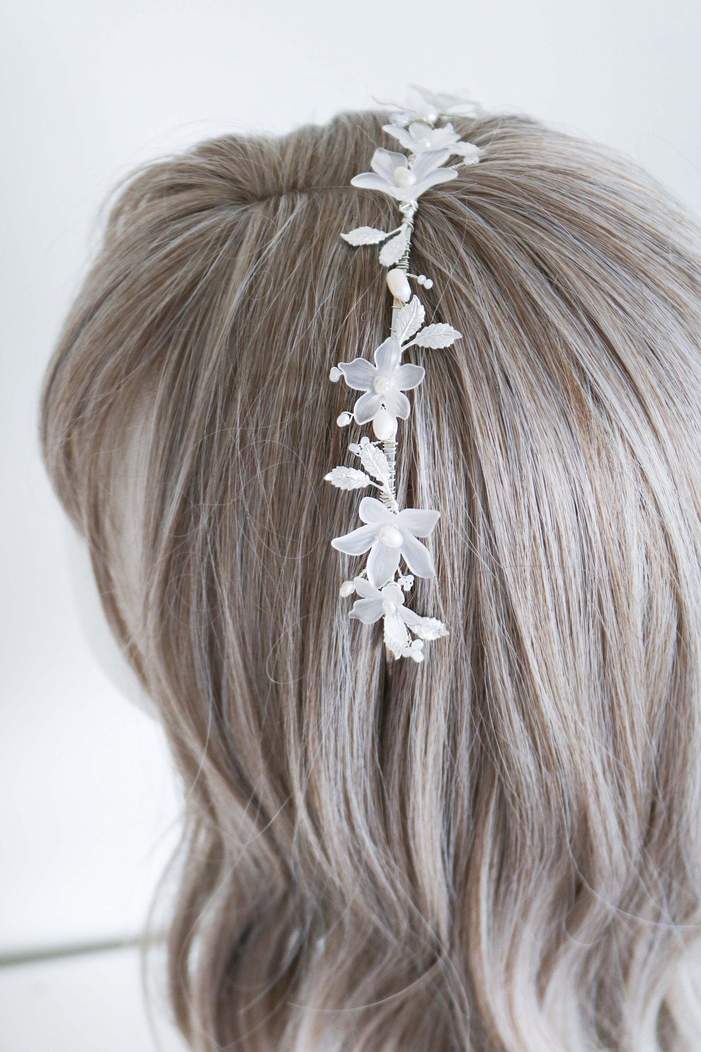 The Melody Fresh Water Pearl and Floral Bridal Headband on a head bust wig. Bridal Hair Accessories. Bridal Accessories. Canadian Bridal Accessories. Handmade Canadian Accessories. Canadian handmade Accessories. Organic pearl accessories. Canadian weddings. Wedding Canada.